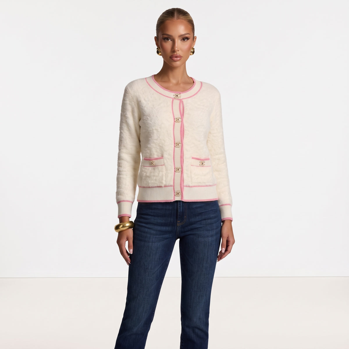 Cream fuzzy cardigan with pink trim and gold Chanel CC buttons