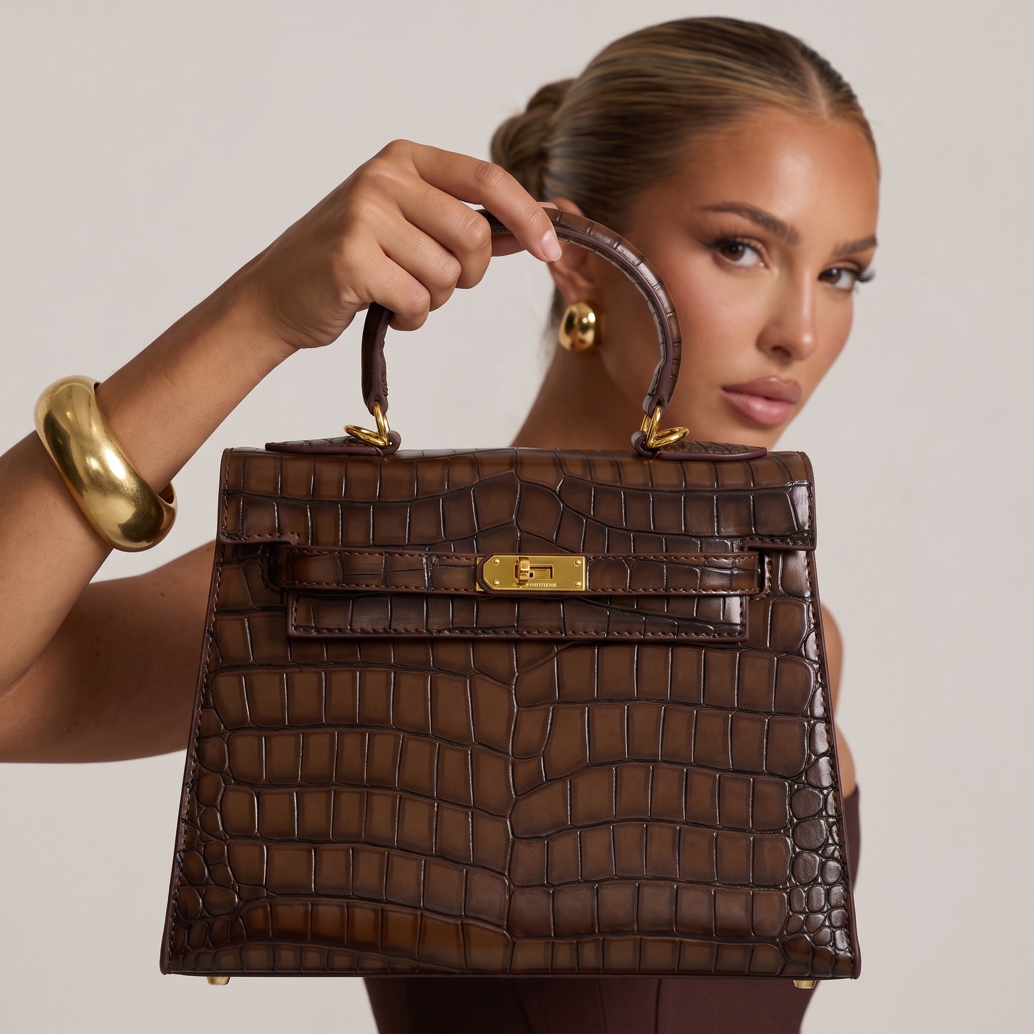 brown croc-embossed top-handle bag with gold turn-lock hardware