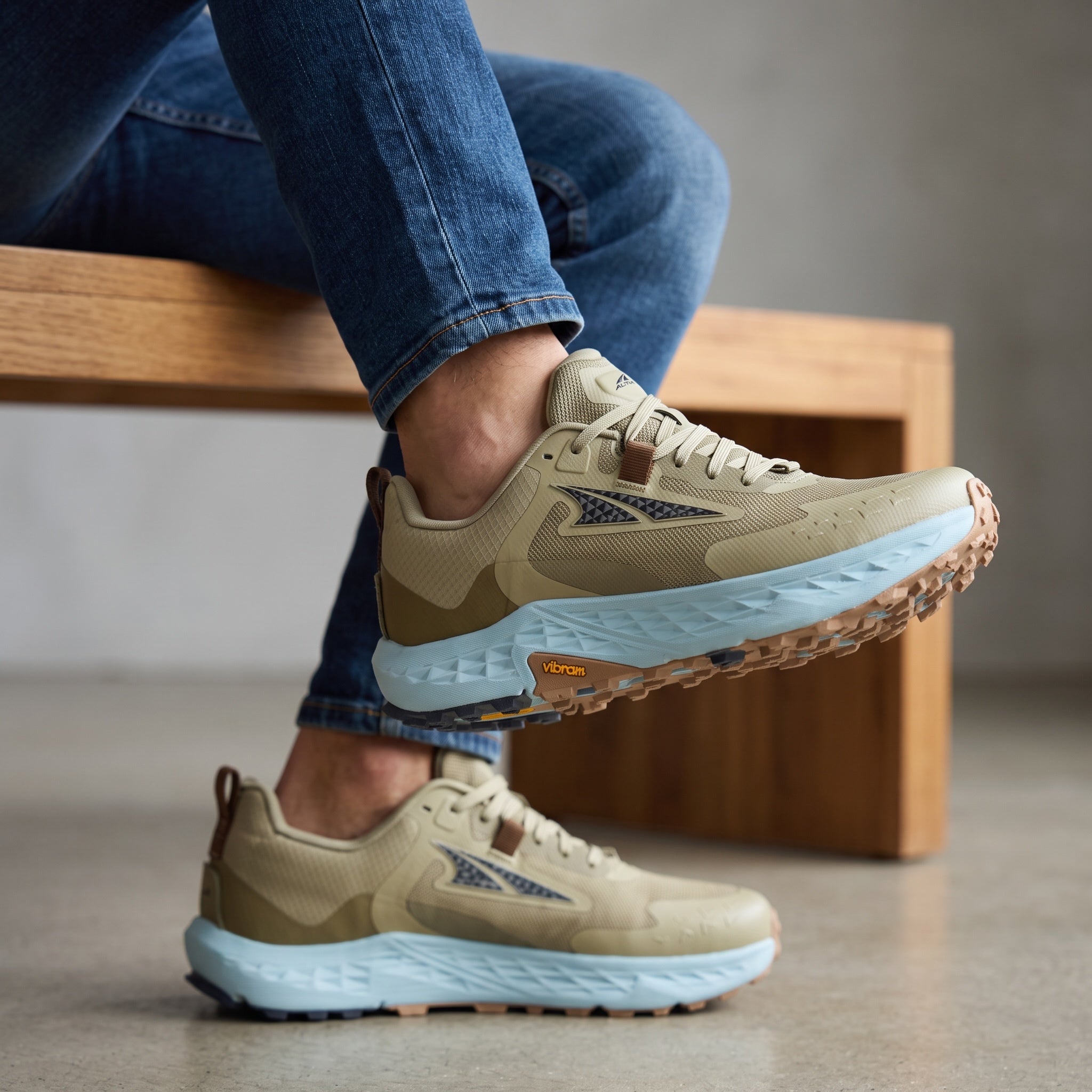 Altra tan trail running shoe with light blue midsole and Vibram sole