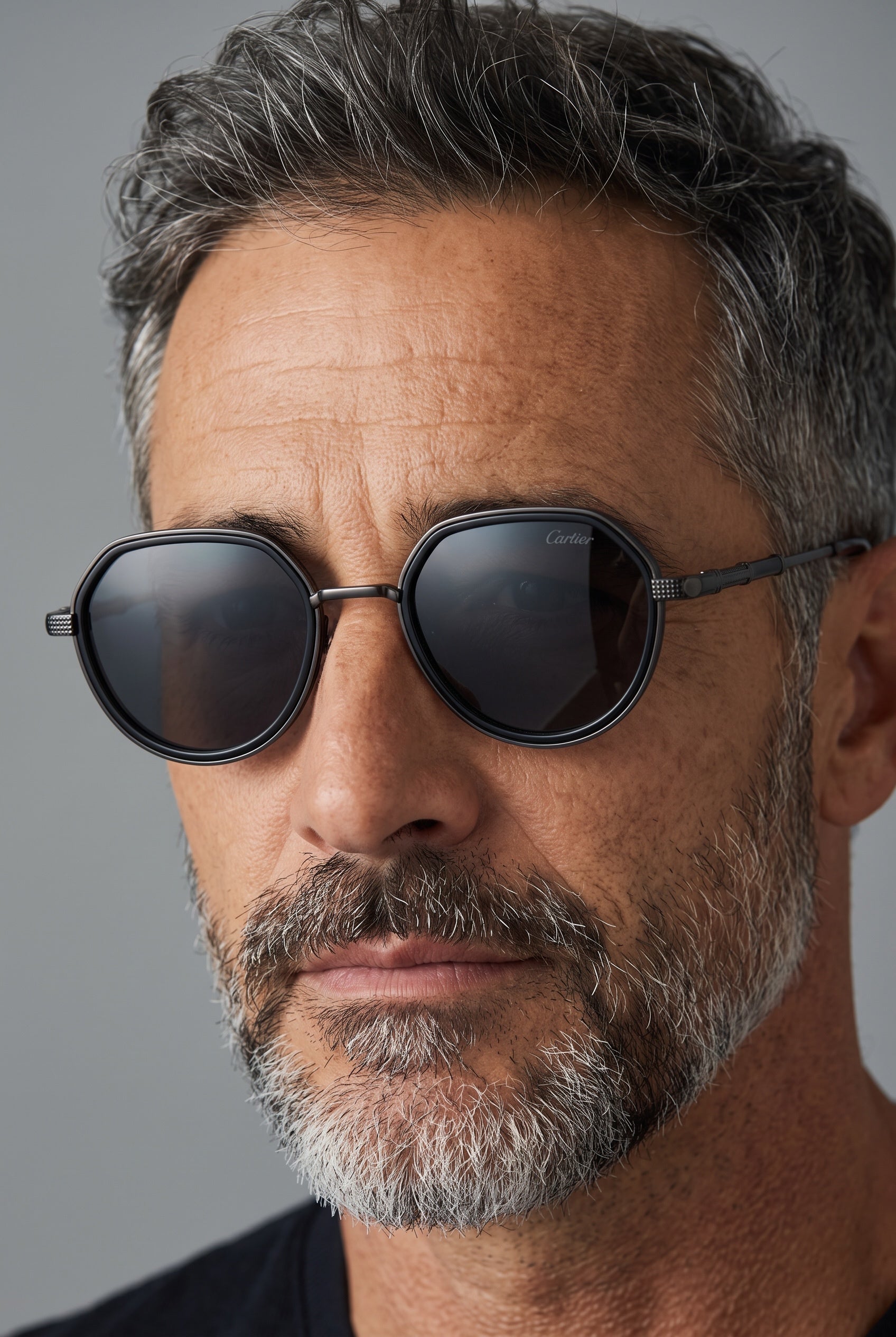 Cartier black metal round sunglasses with smoked lenses on male model