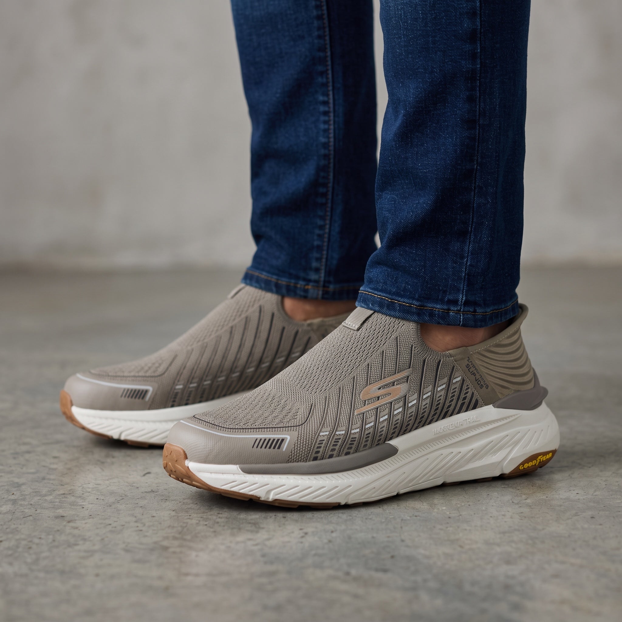 taupe Skechers slip-on knit sneakers with white cushioned sole and Goodyear outsole