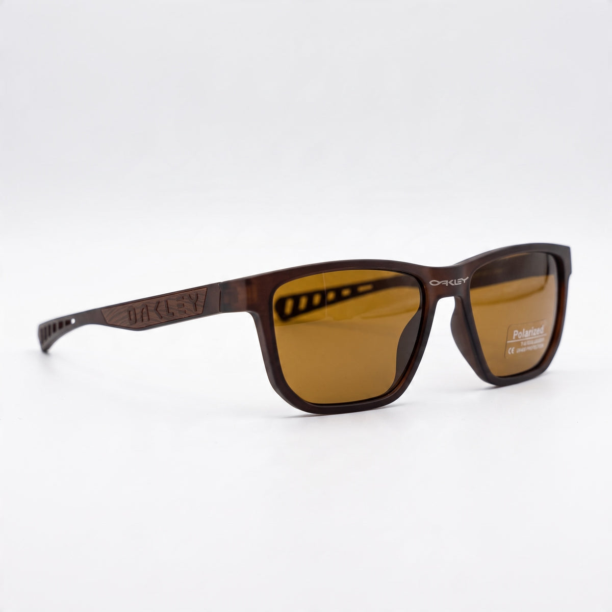 Oakley brown frame sunglasses with brown polarized lenses, angled front view.