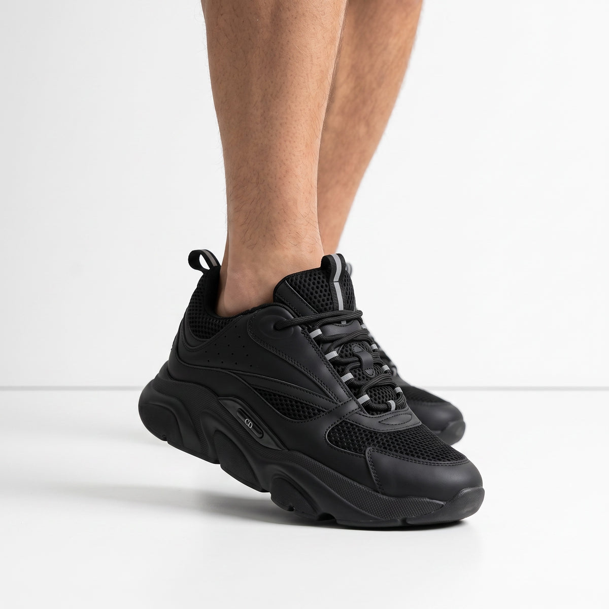 All-black Dior chunky low-top sneakers with mesh panels and chunky sole