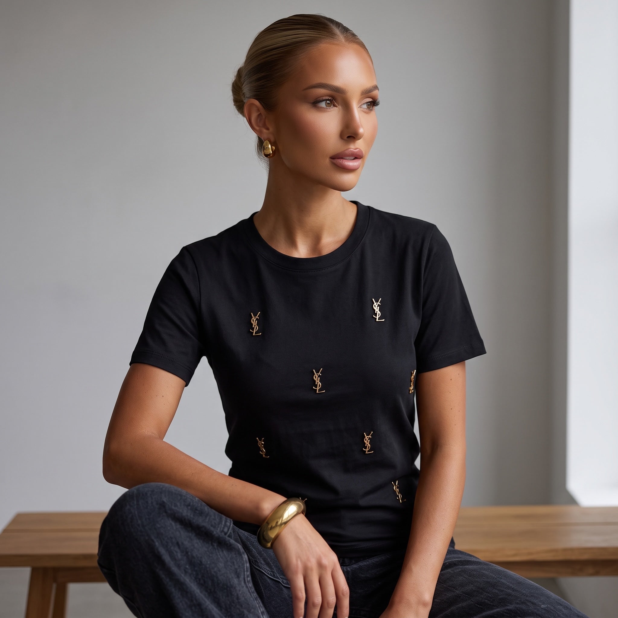 Black Saint Laurent T‑shirt with scattered gold YSL monogram pins