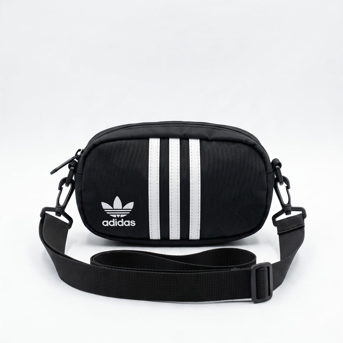 black Adidas mini crossbody bag with white three stripes and trefoil logo