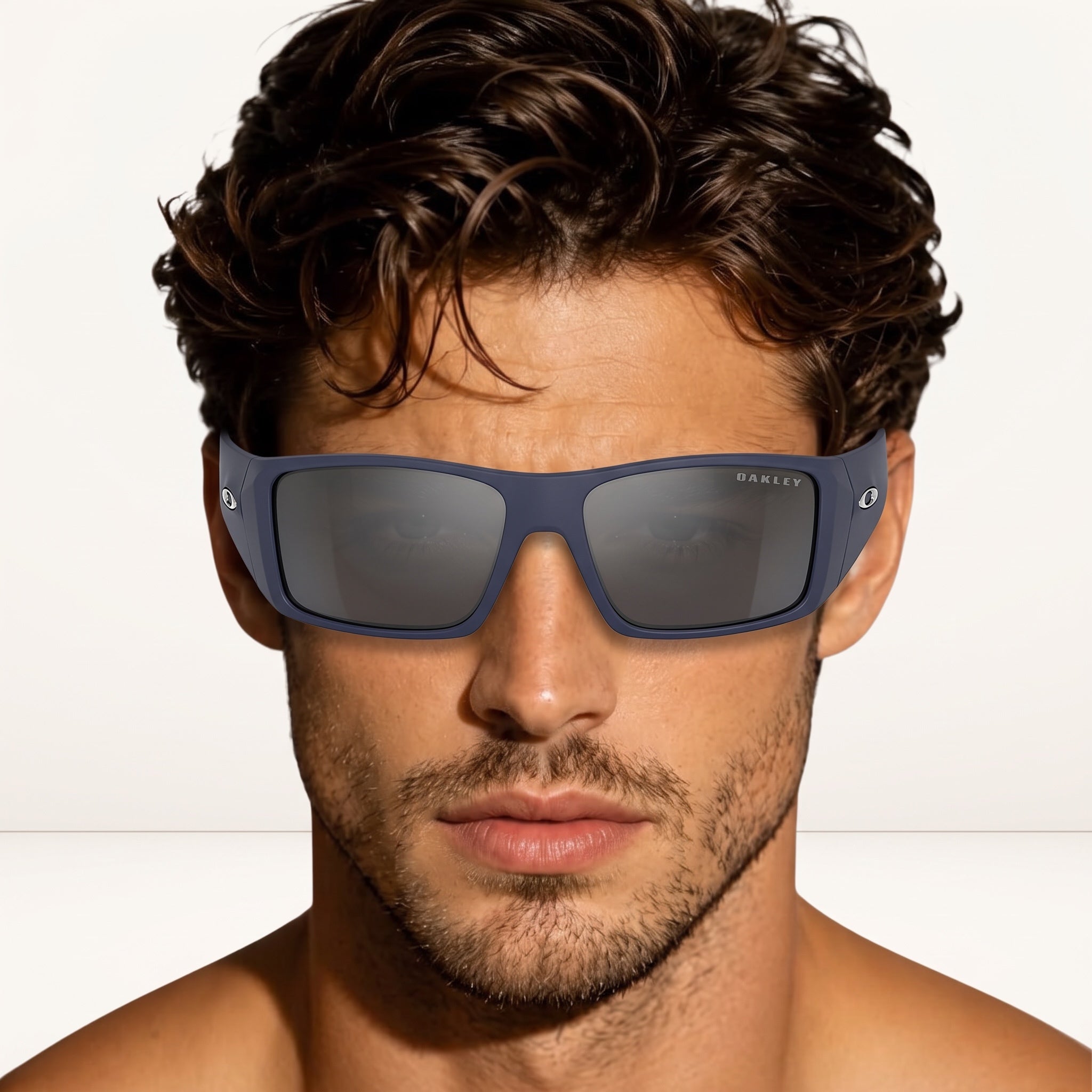 Oakley matte blue rectangular sunglasses on a male model