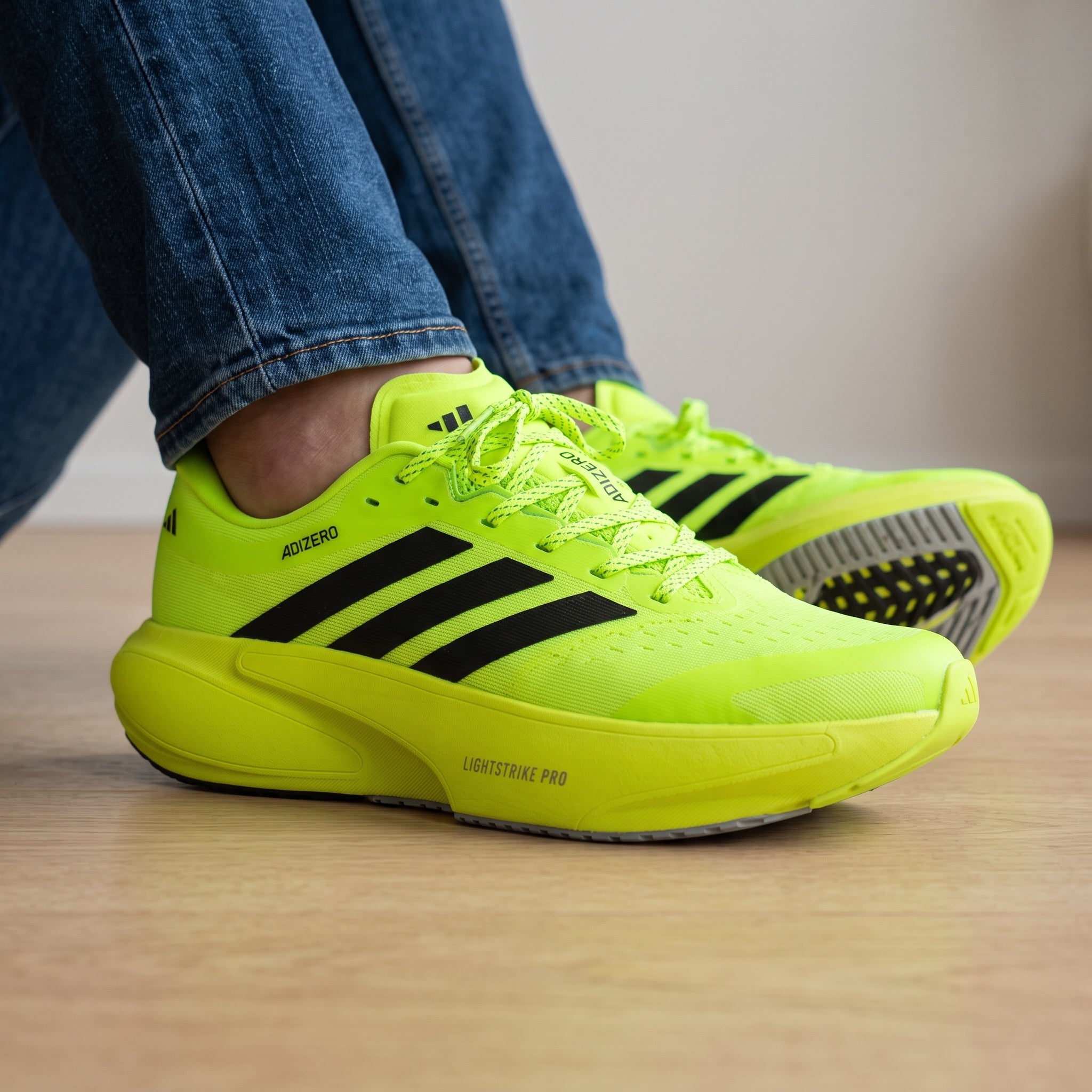 Adidas Adizero Supernova neon yellow running sneakers with black stripes
