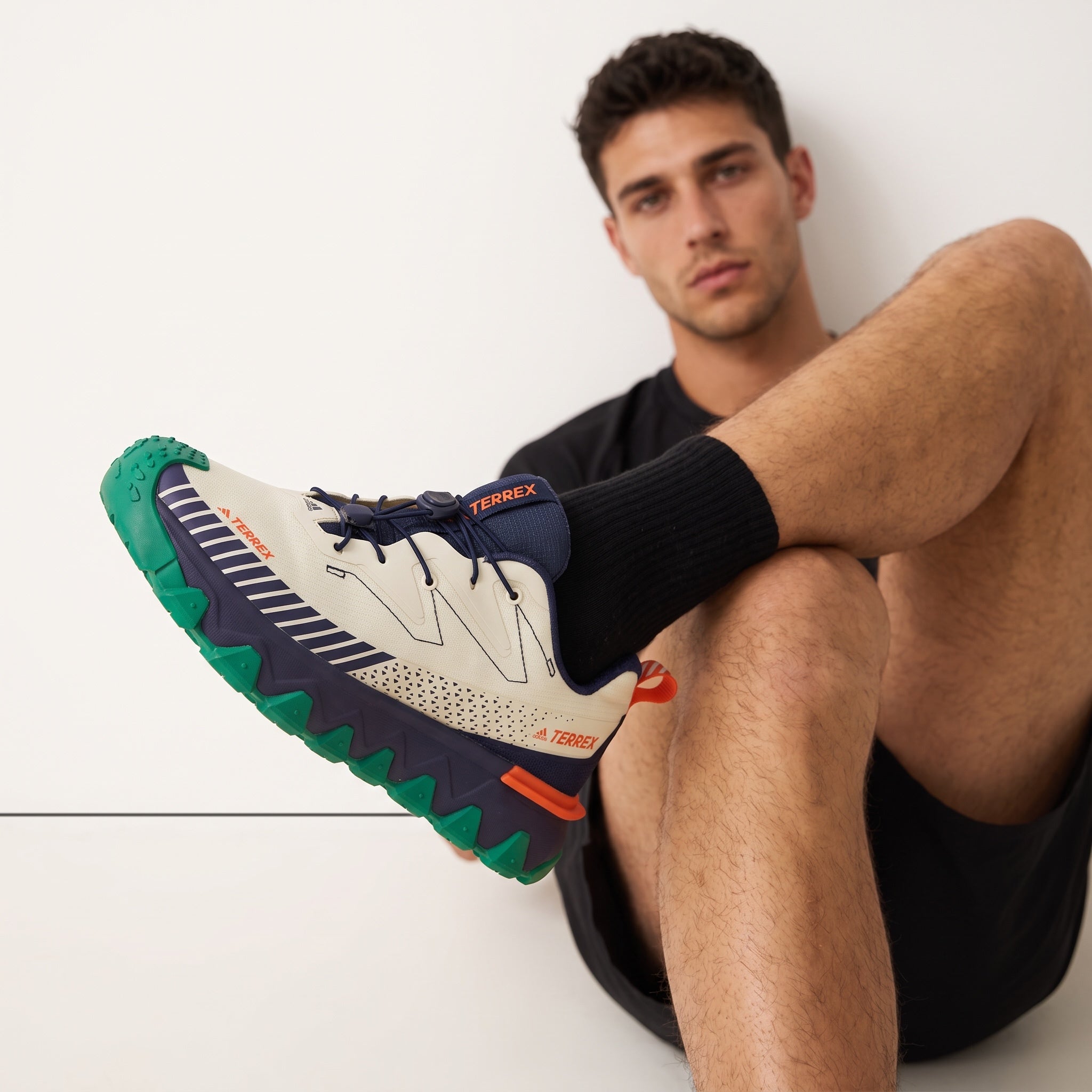 Adidas Terrex cream and navy trail sneakers with green lug sole and orange heel tab