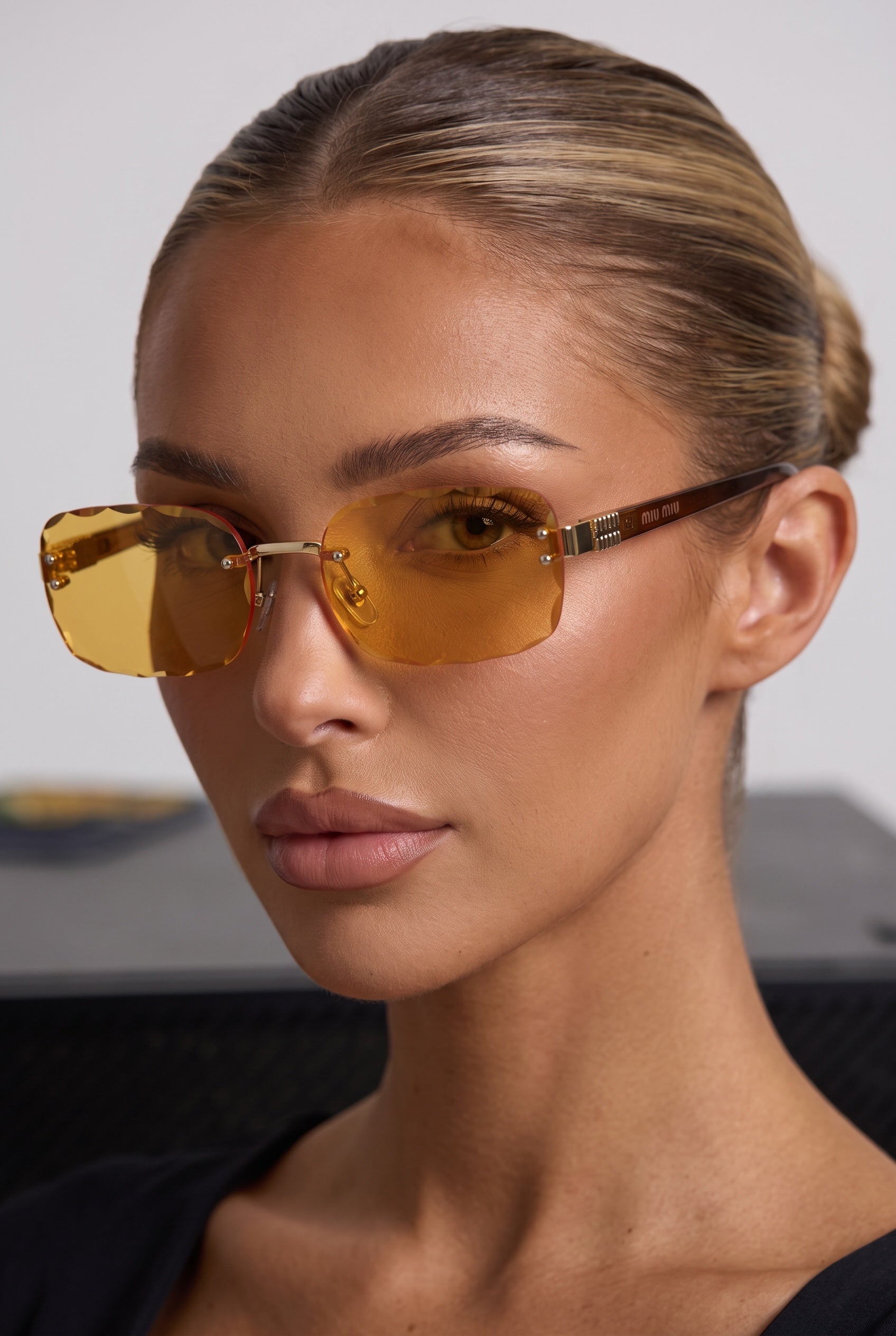 Miu Miu frameless sunglasses with amber lenses and gold hardware