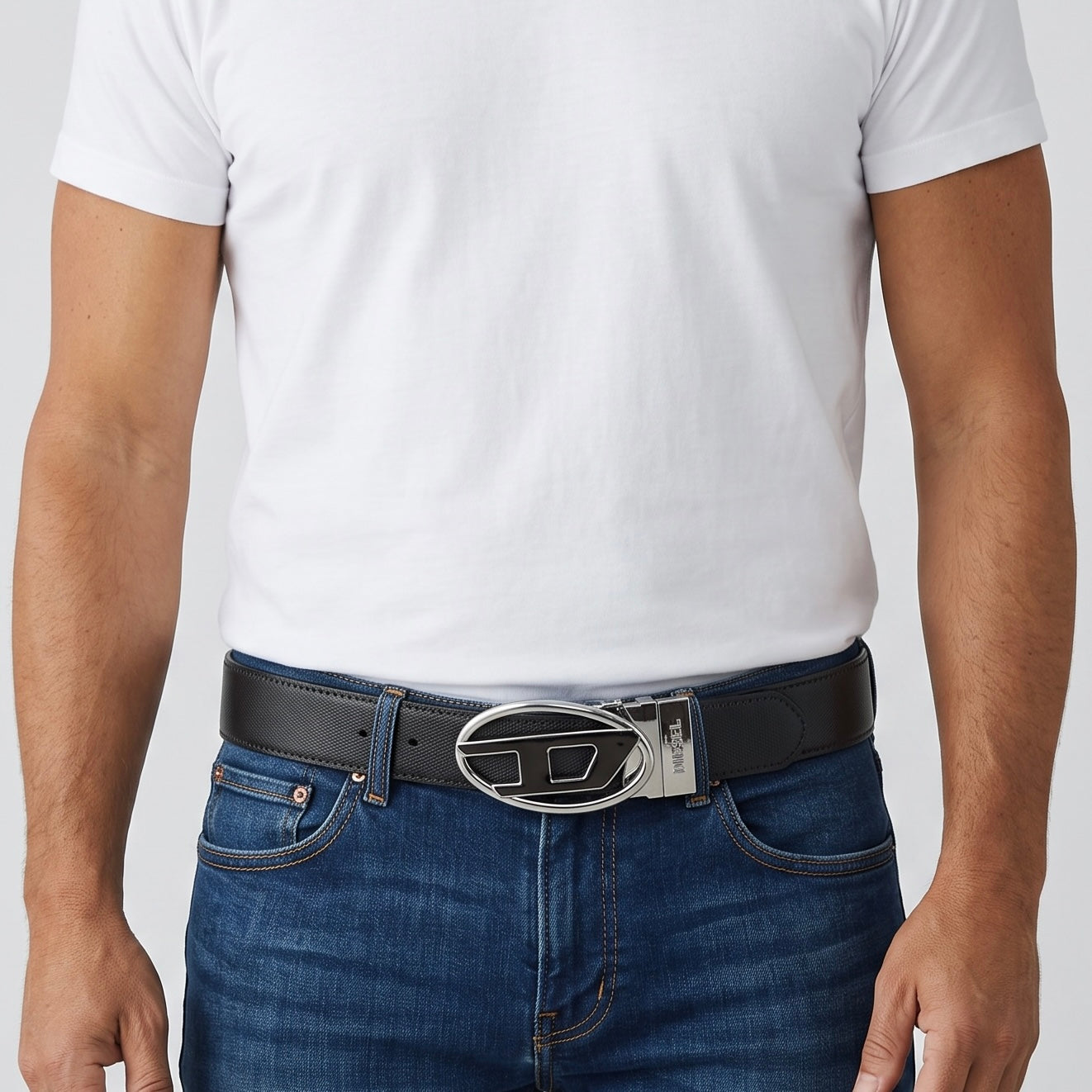 Men wearing black Diesel belt with oval metal buckle
