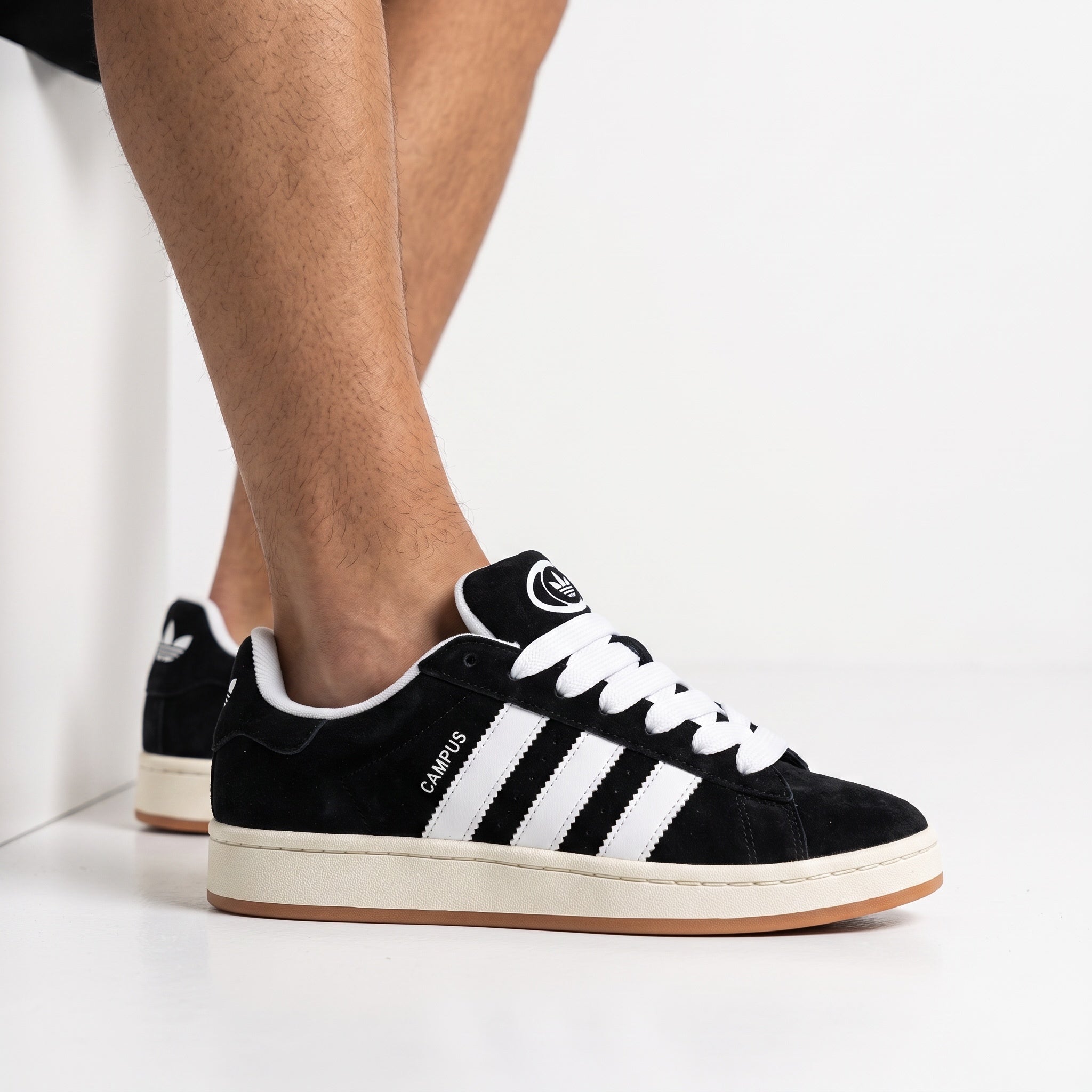adidas Campus black and white sneakers on foot, side view