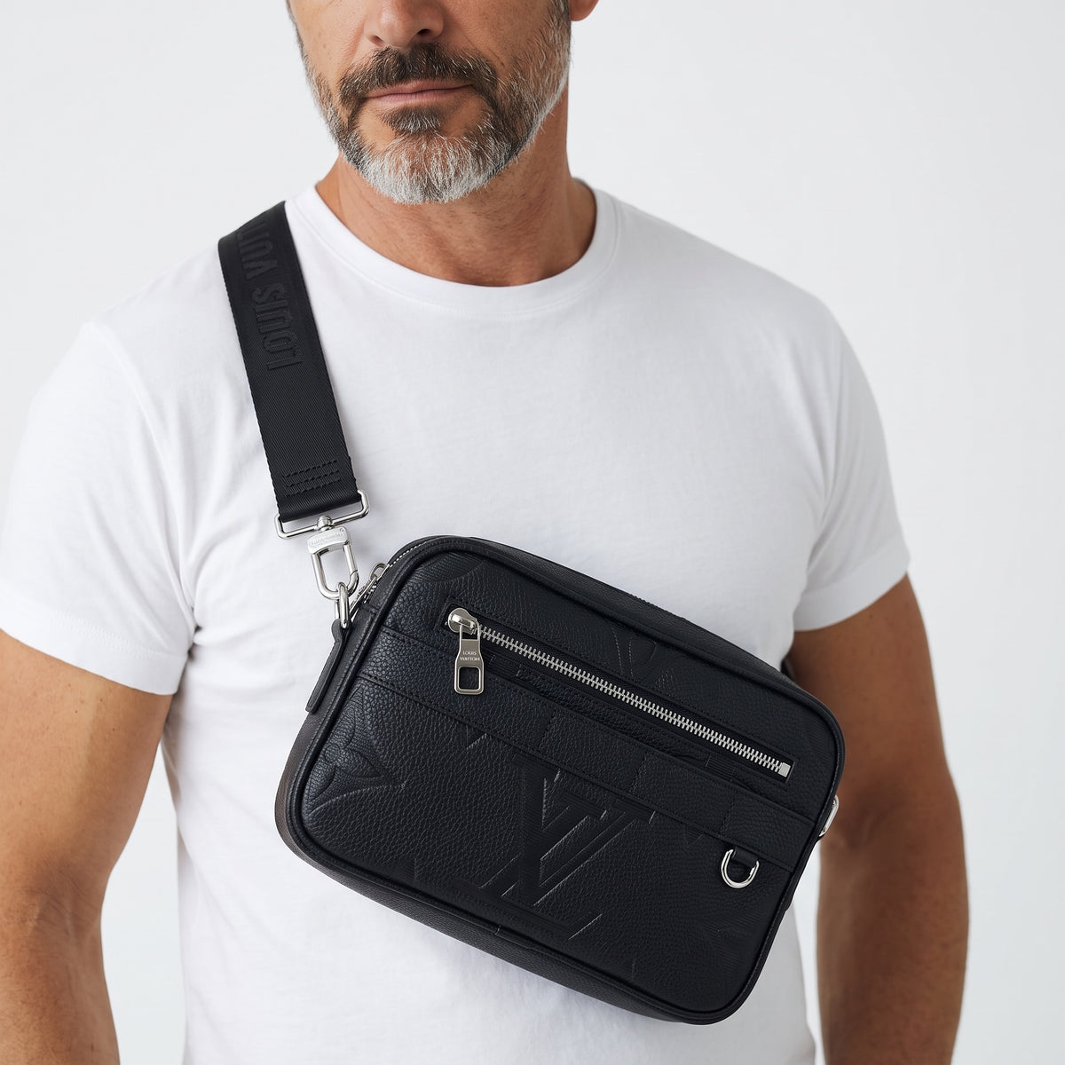 Black Louis Vuitton embossed crossbody sling with silver zipper and logo strap