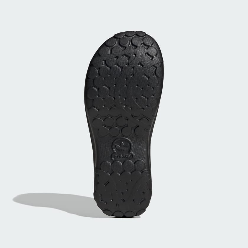 black adidas platform slide sandal with embossed trefoil