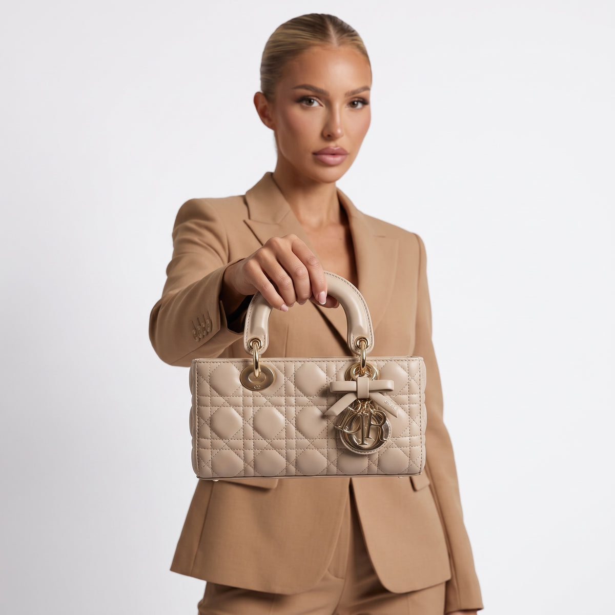 beige quilted Lady Dior handbag with top handles and gold charms