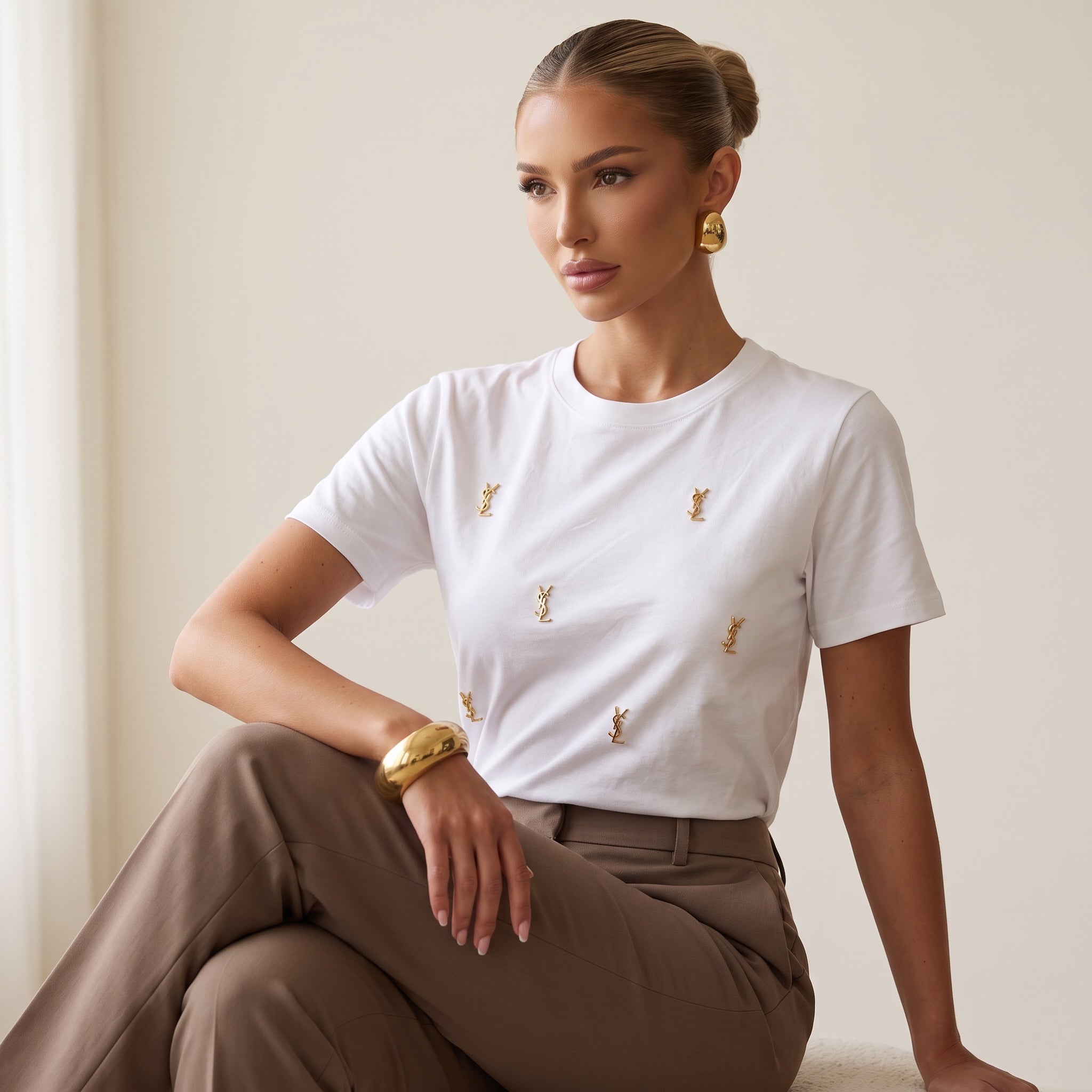White Saint Laurent T-shirt with multiple small gold YSL logo studs on the front