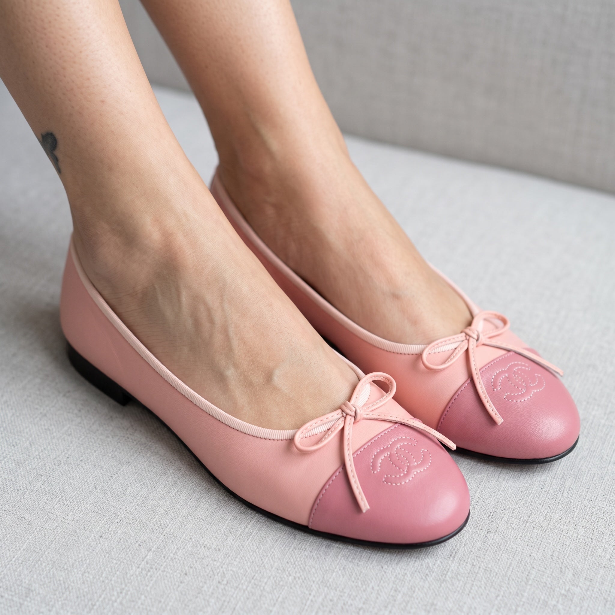 pink Chanel cap-toe ballerina flats with stitched CC logo