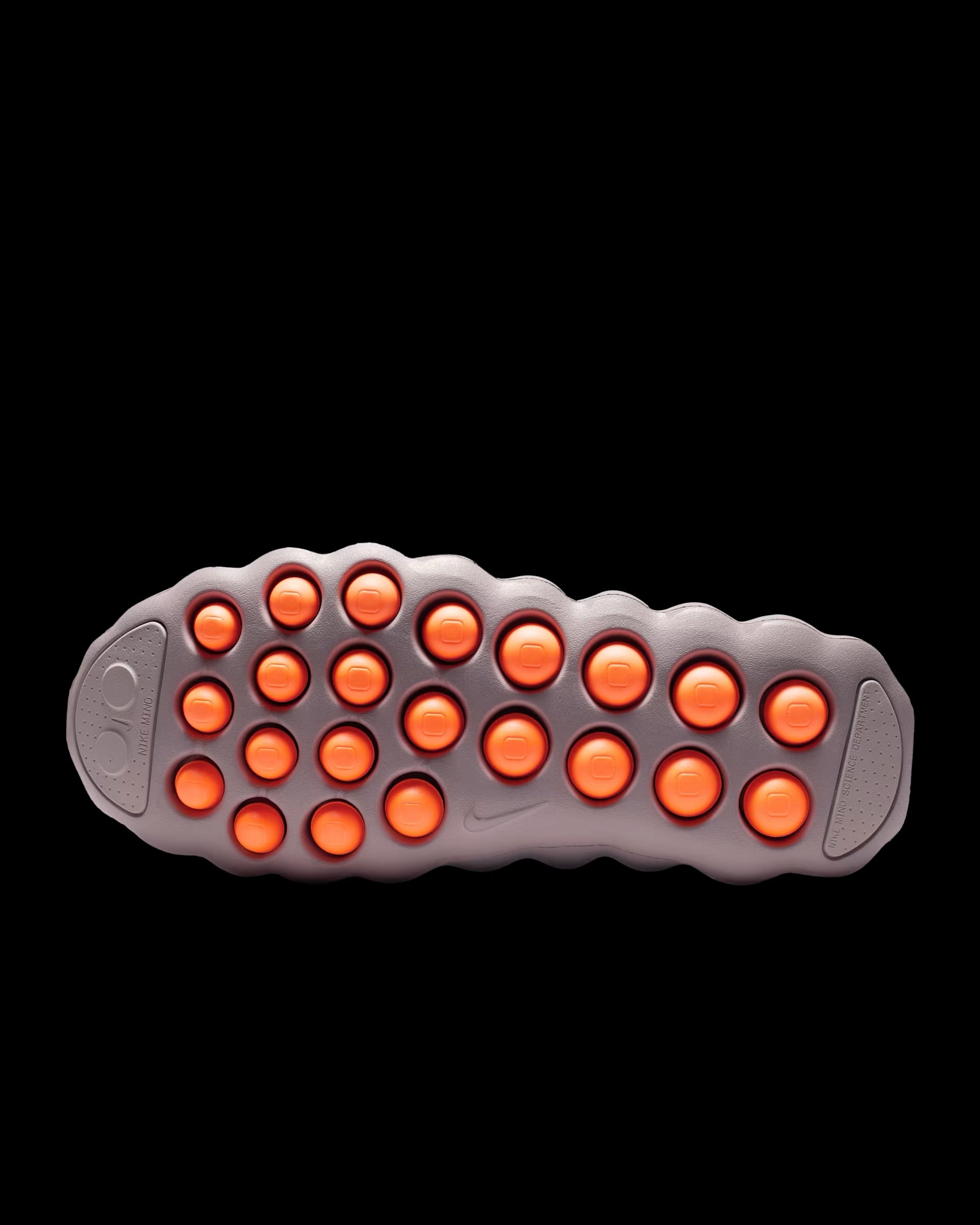 dusty pink nike sneaker with perforated upper and orange pod outsole