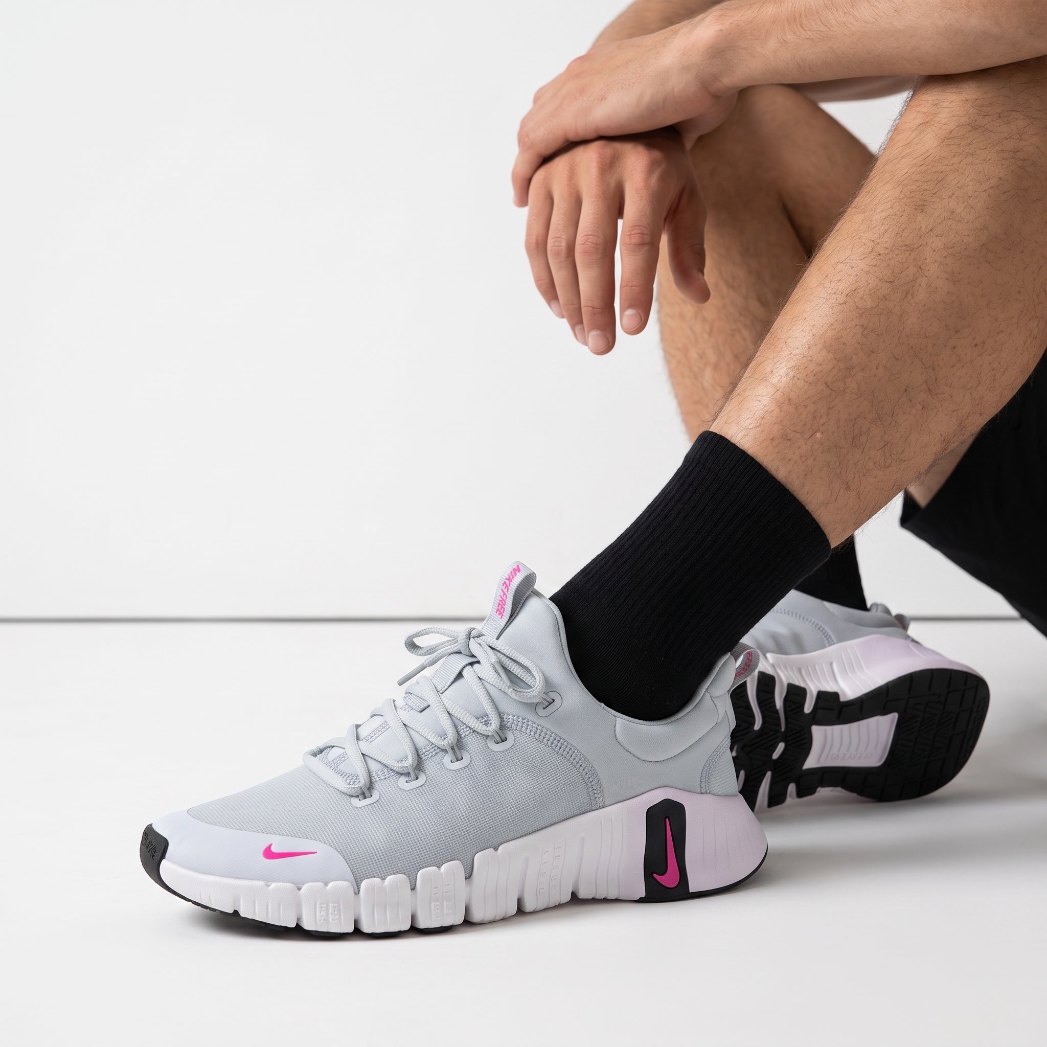 light grey Nike Free trainer sneaker with pink Swoosh accents