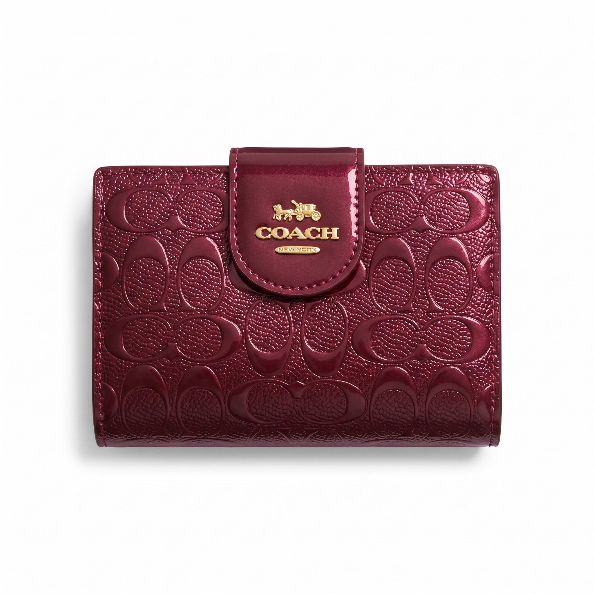 burgundy Coach compact card wallet with embossed signature pattern and gold logo