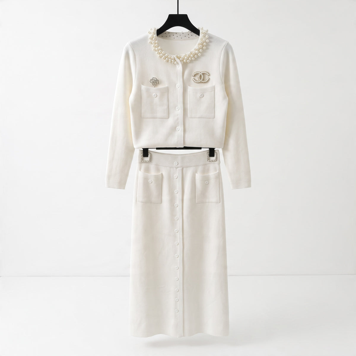 Cream cropped cardigan with pearl collar, chest pockets and decorative brooches