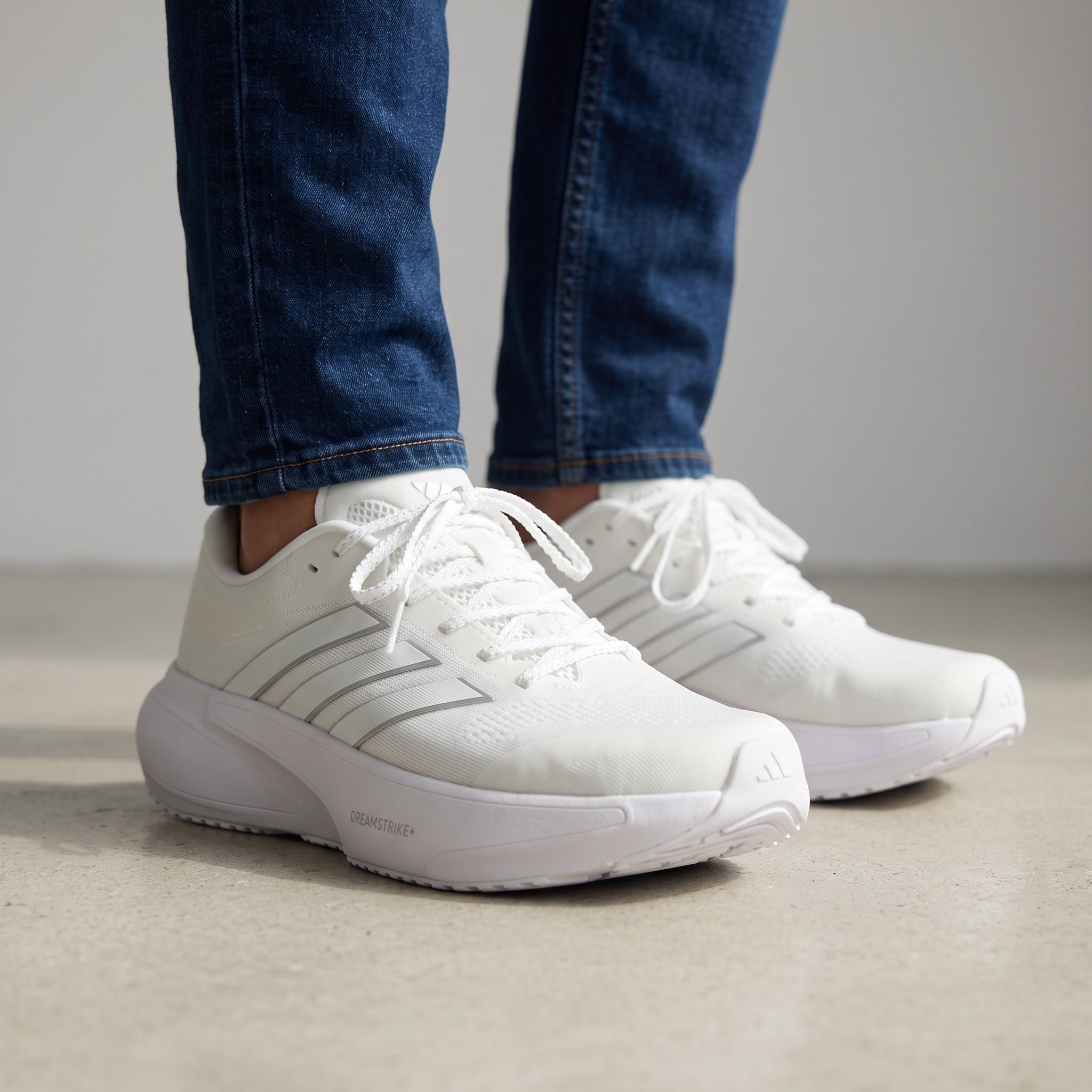 All‑white Adidas low-cut sneakers with chunky sole and three stripes