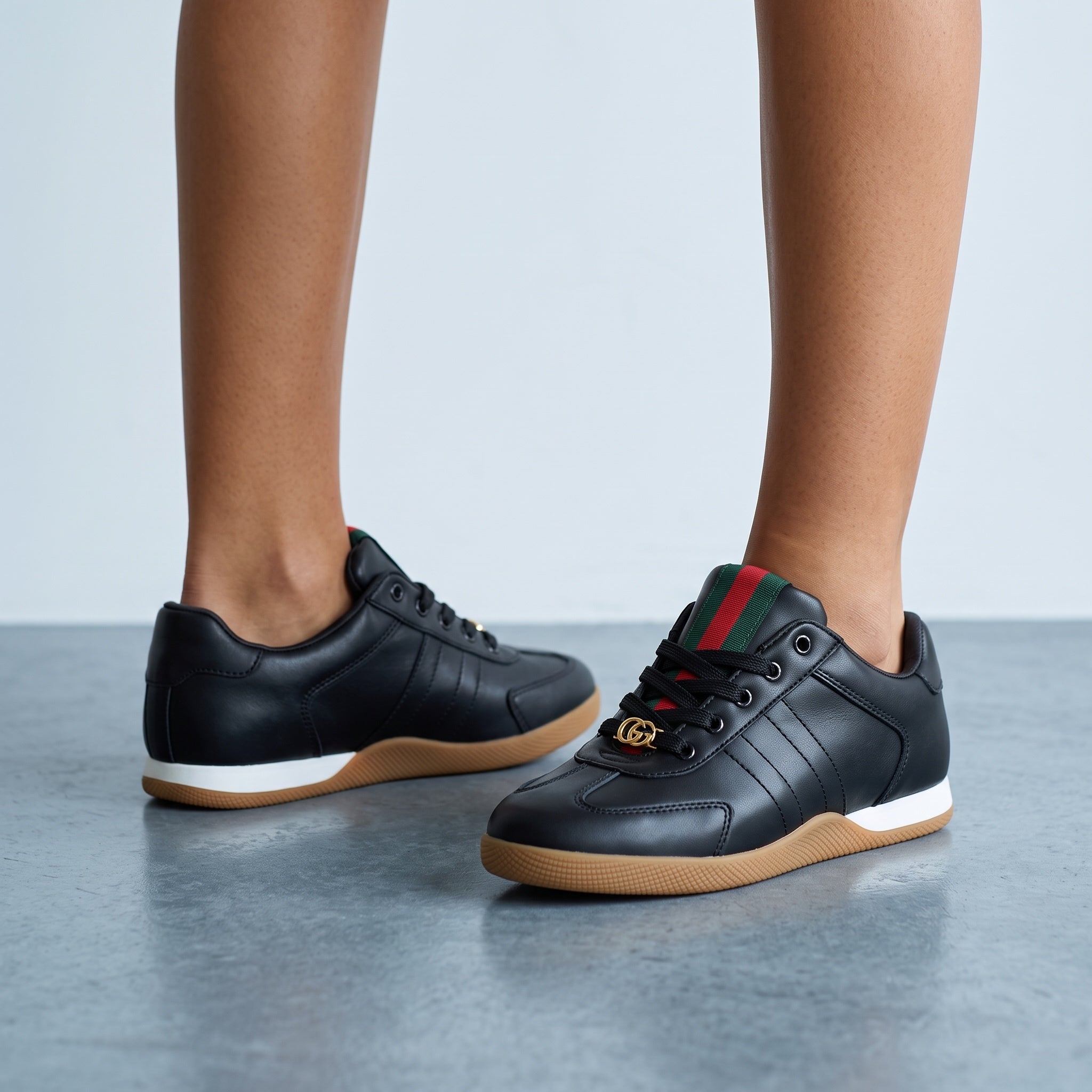 black Gucci Ace sneakers with green red web and gold GG on gum sole