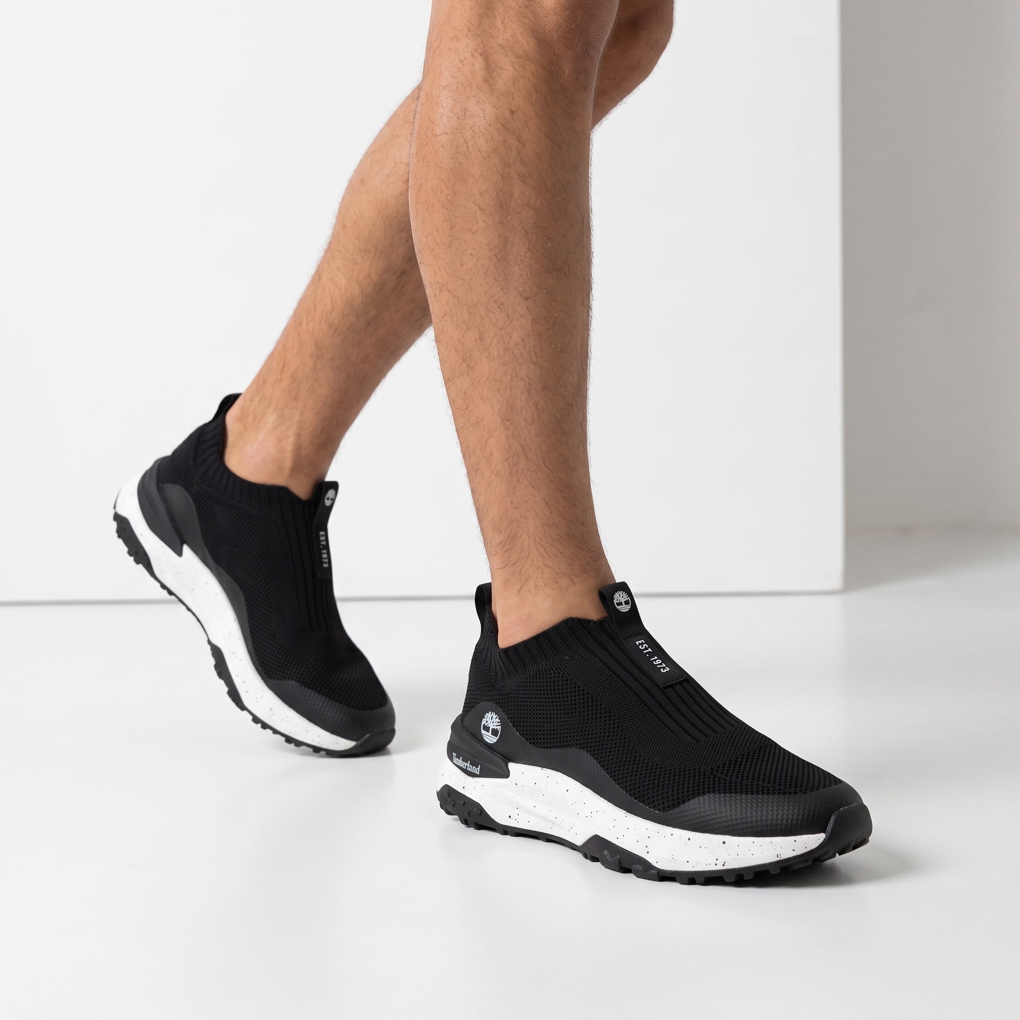 Timberland black slip-on knit sneaker with speckled white midsole shown on model