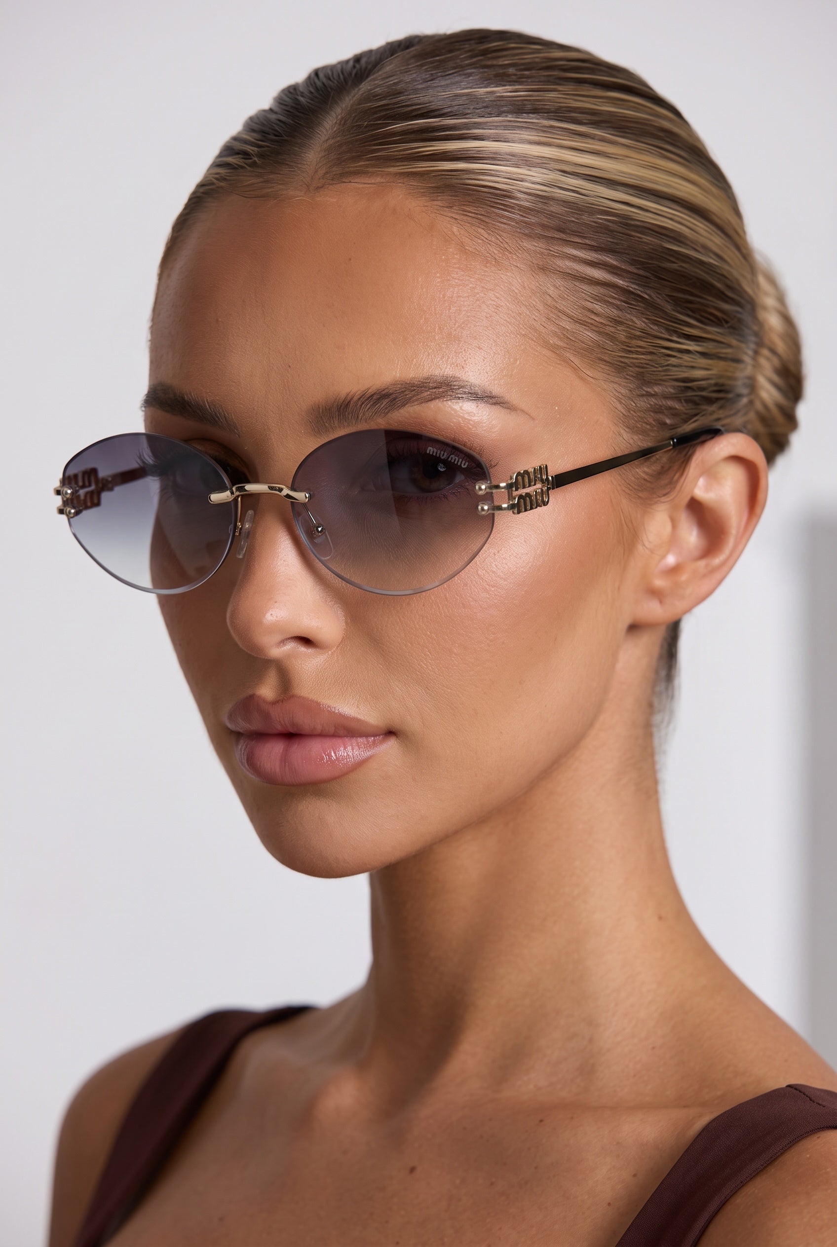 Miu Miu rimless oval sunglasses with smoke gradient lenses and gold logo hinge