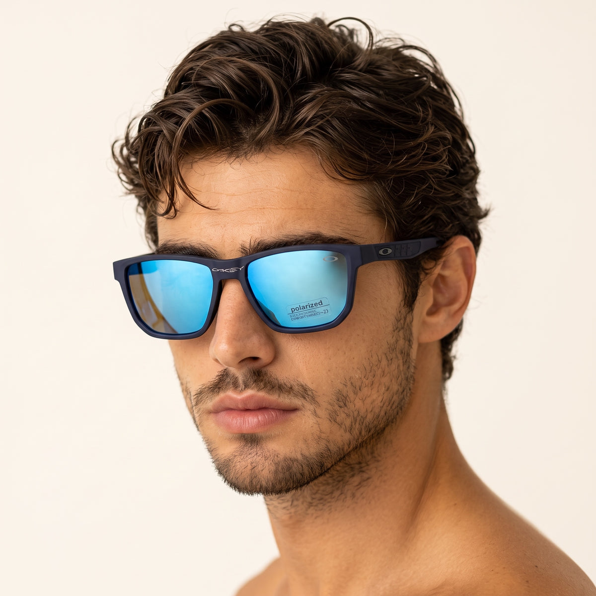 Oakley matte blue square sunglasses with blue mirrored polarized lenses on male model