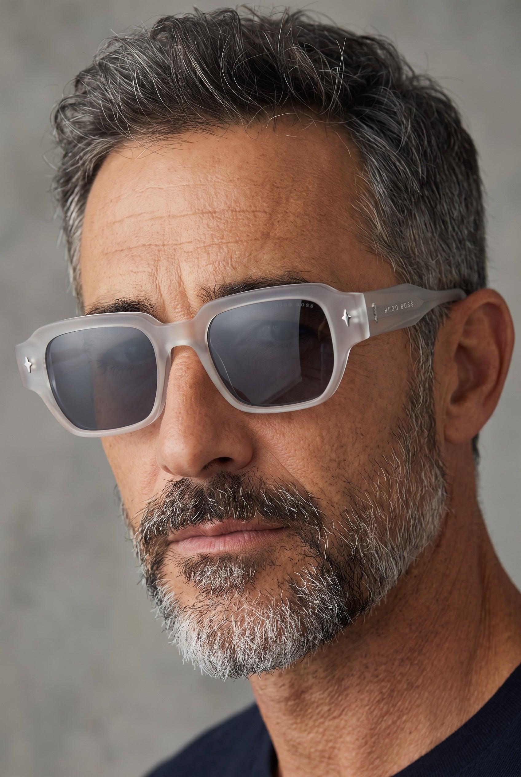 Hugo Boss frosted translucent grey square sunglasses with dark lenses on male model