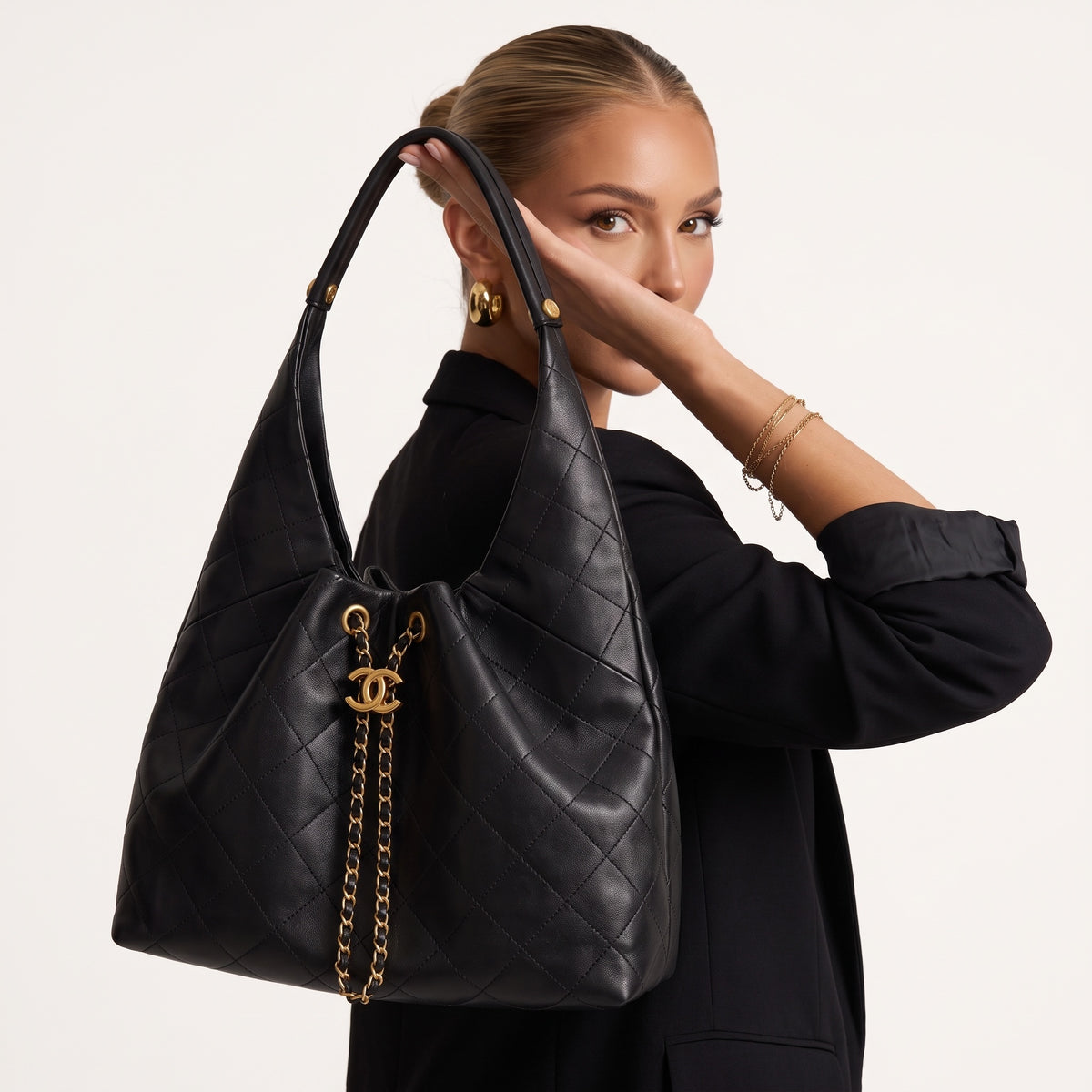 Black quilted Chanel hobo bag with gold CC charm and chain