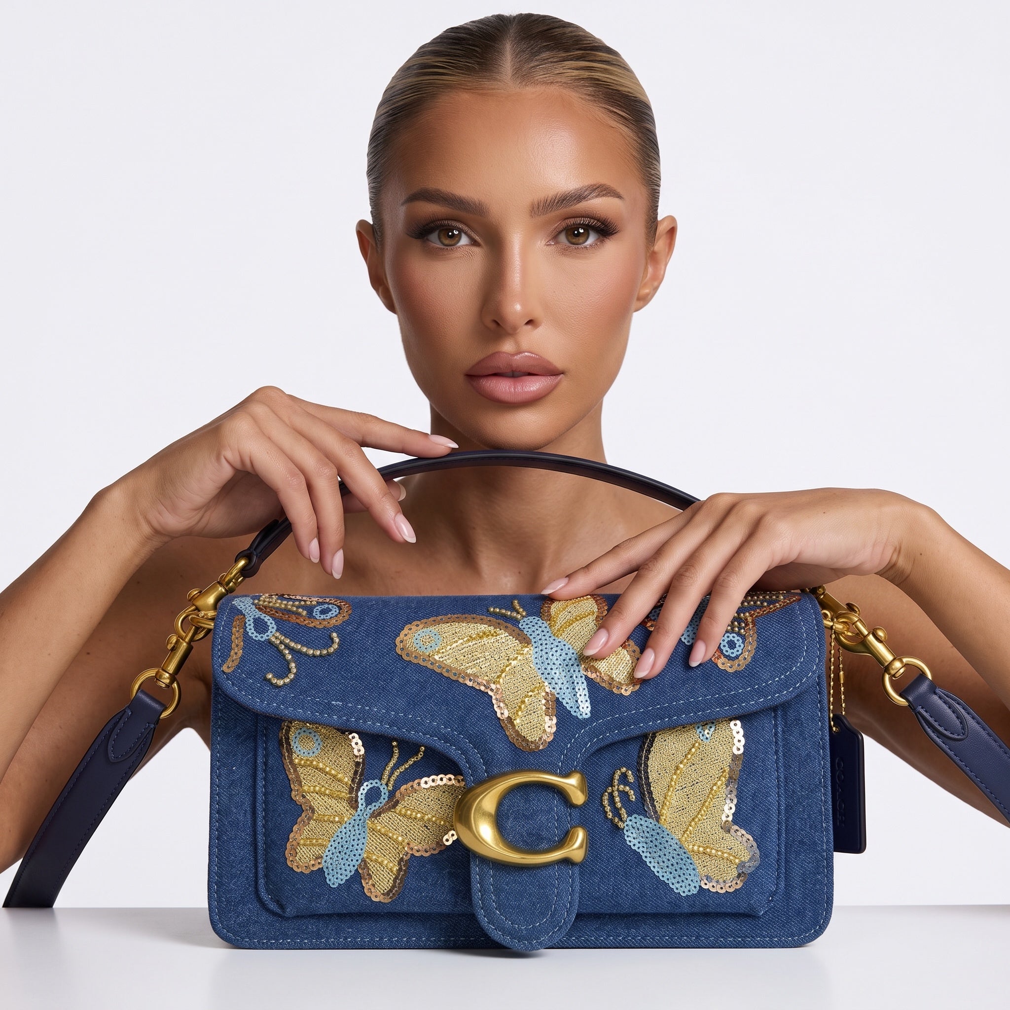 Blue Coach denim shoulder bag with sequin butterfly embroidery and gold C hardware