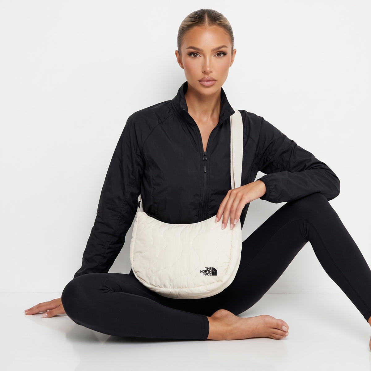 Ivory quilted The North Face crossbody bag with adjustable strap