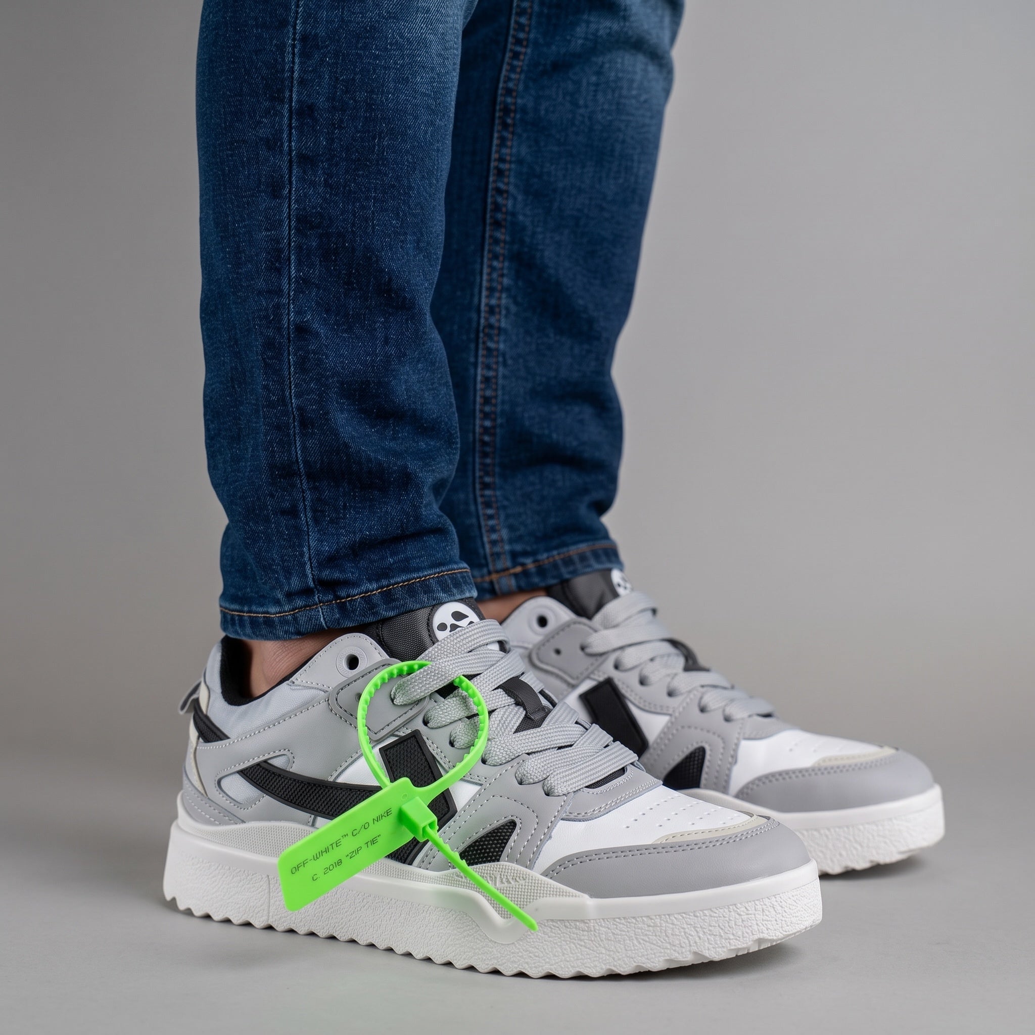 Off-White x Nike grey low-top sneakers with neon green zip tie