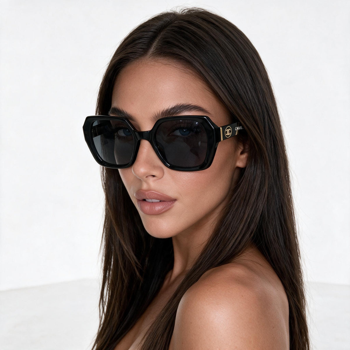 Chanel oversized black sunglasses with gold CC logo on temple
