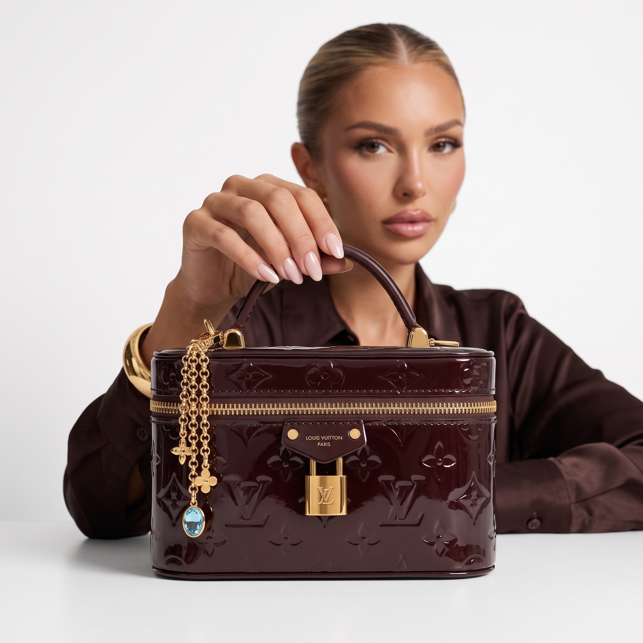 Louis Vuitton small burgundy patent monogram vanity bag with gold hardware and chain charm