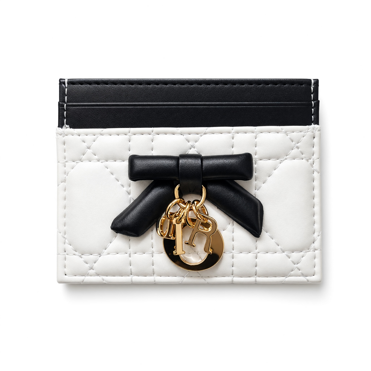 White quilted Dior card holder with black bow and gold letter charms, top card slots visible