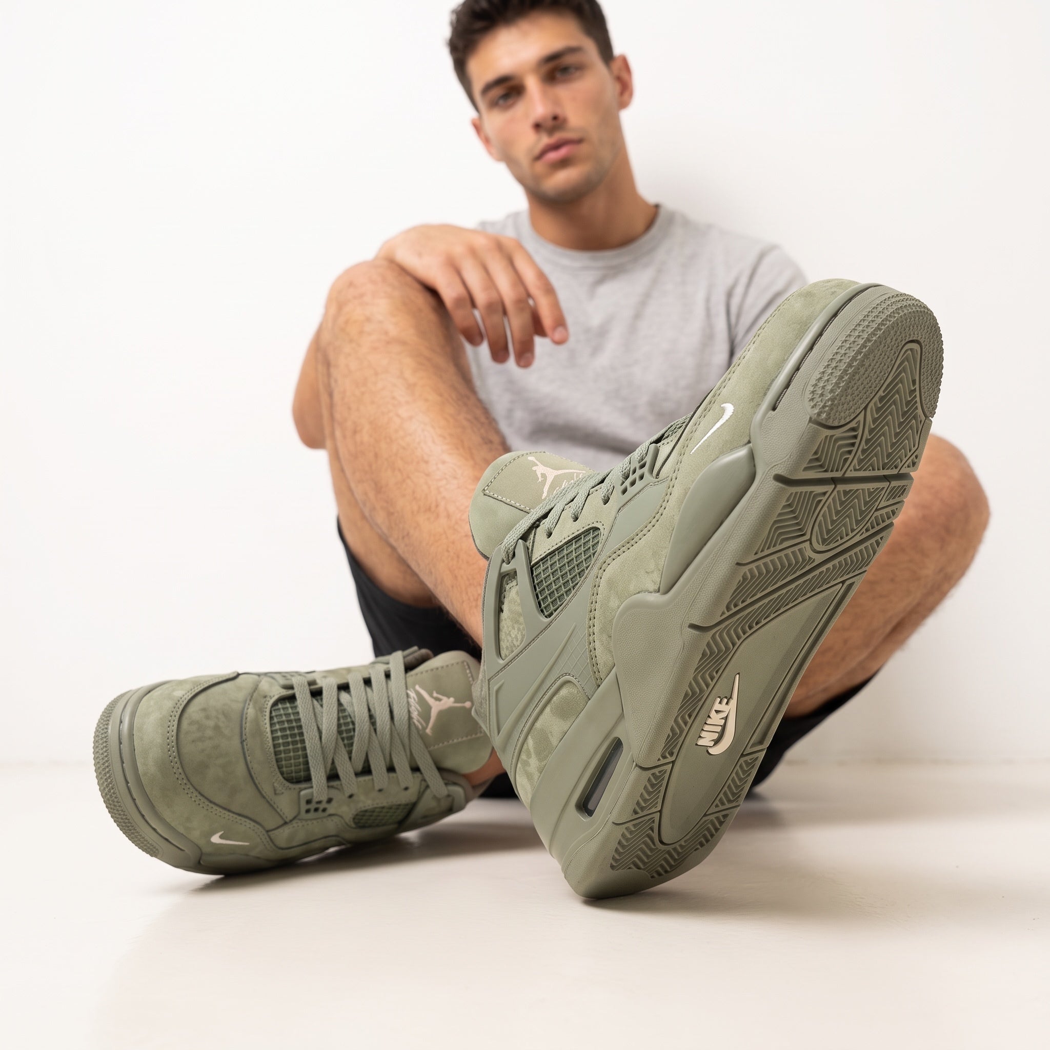 Olive green Air Jordan 4 sneakers with Jumpman tongue and NIKE AIR heel branding