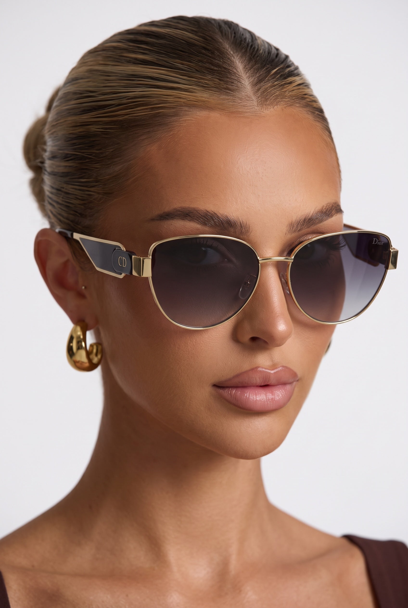 Dior aviator sunglasses with gold frame black temple panels and gradient lenses
