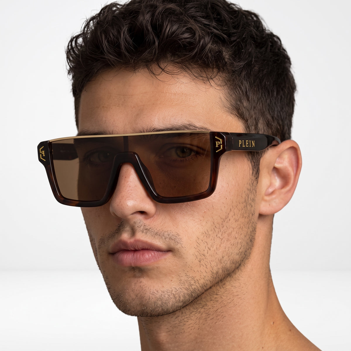 Close-up of men's Plein tortoiseshell oversized shield sunglasses with brown lenses