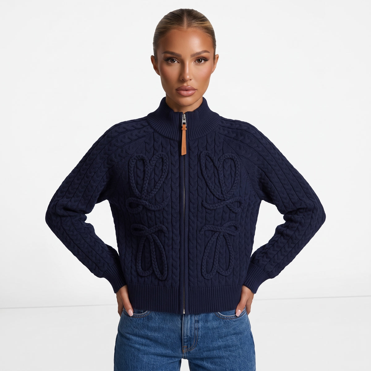 Navy cable-knit zip jacket with braided bow details and leather zipper pull