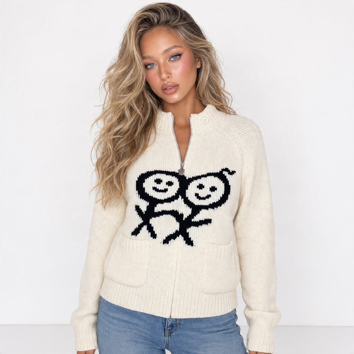 Cream zip knit sweater with black smiley motif and front pockets