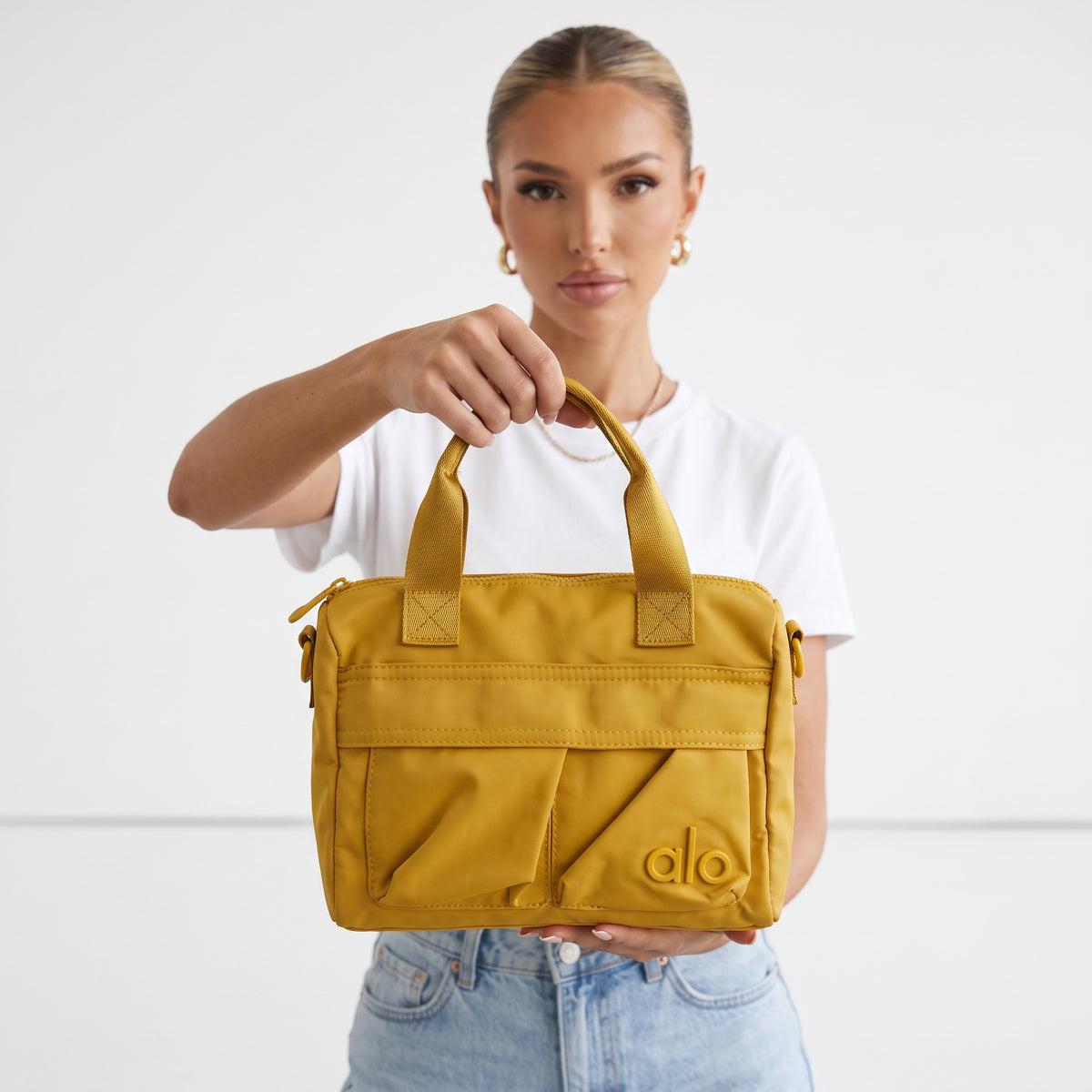 Alo mustard mini tote bag with top handles and front pockets