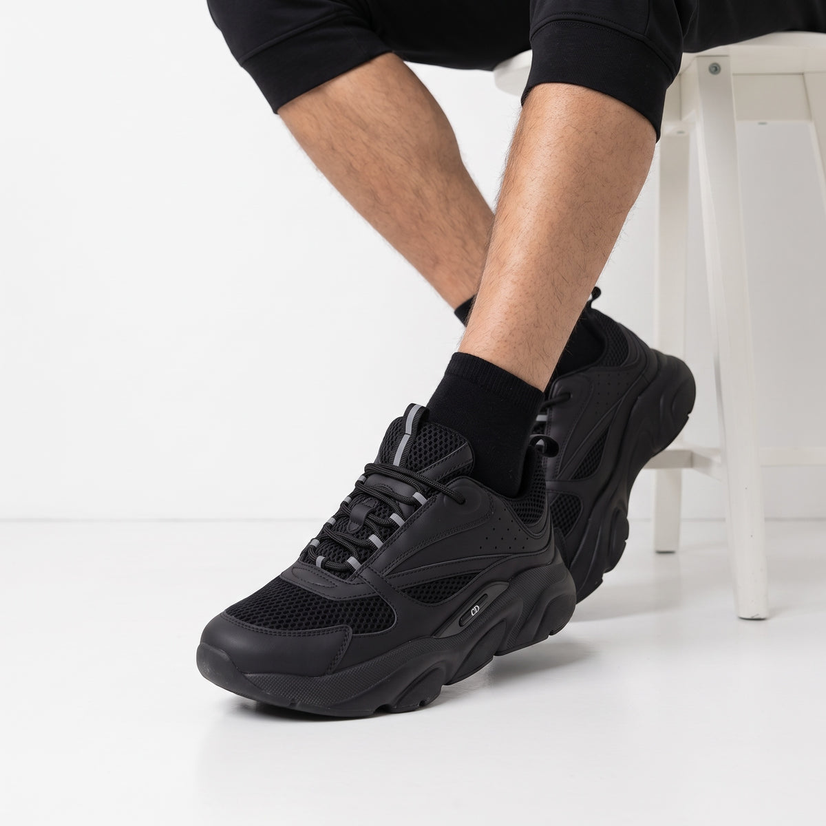 All-black Dior chunky low-top sneakers with mesh panels and chunky sole