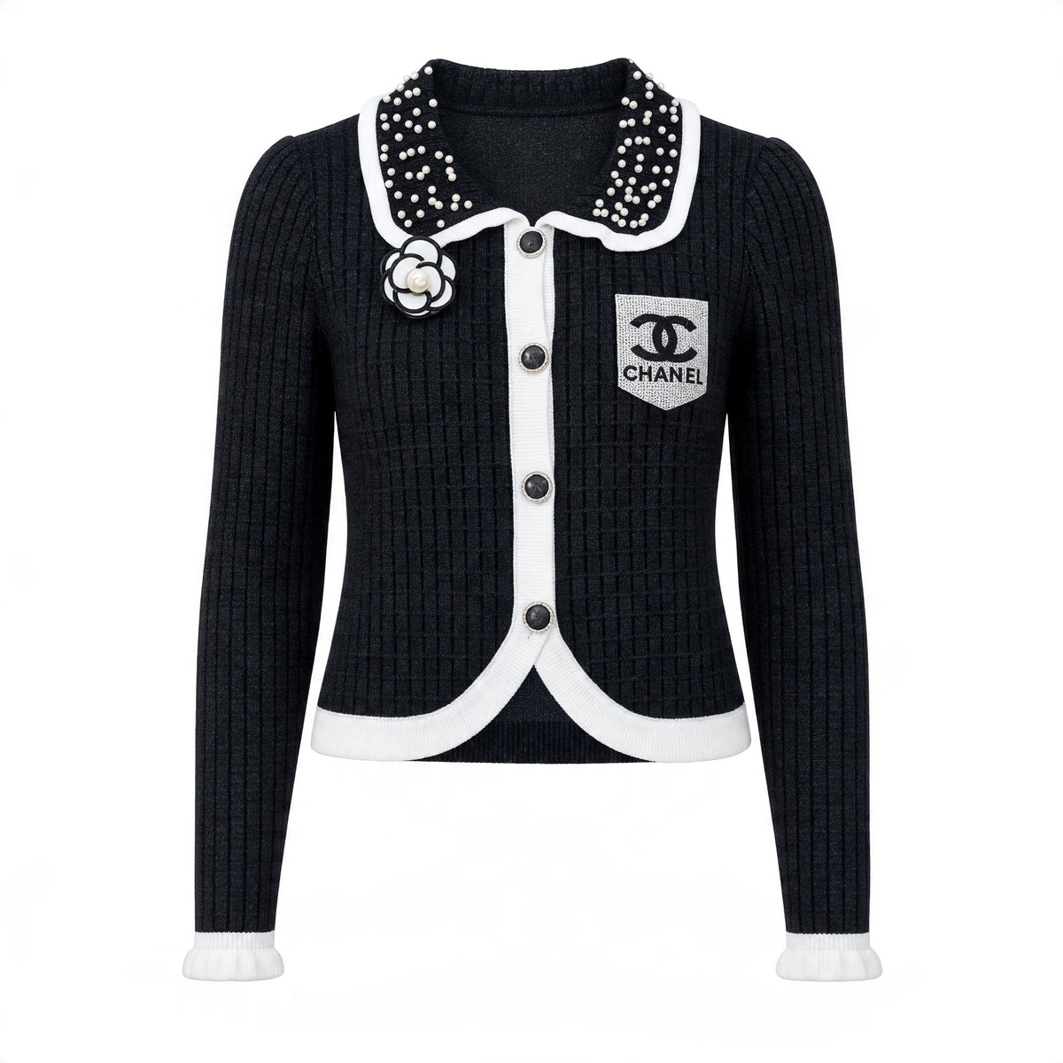 Black ribbed Chanel cardigan with pearl-studded collar, camellia brooch and white trim