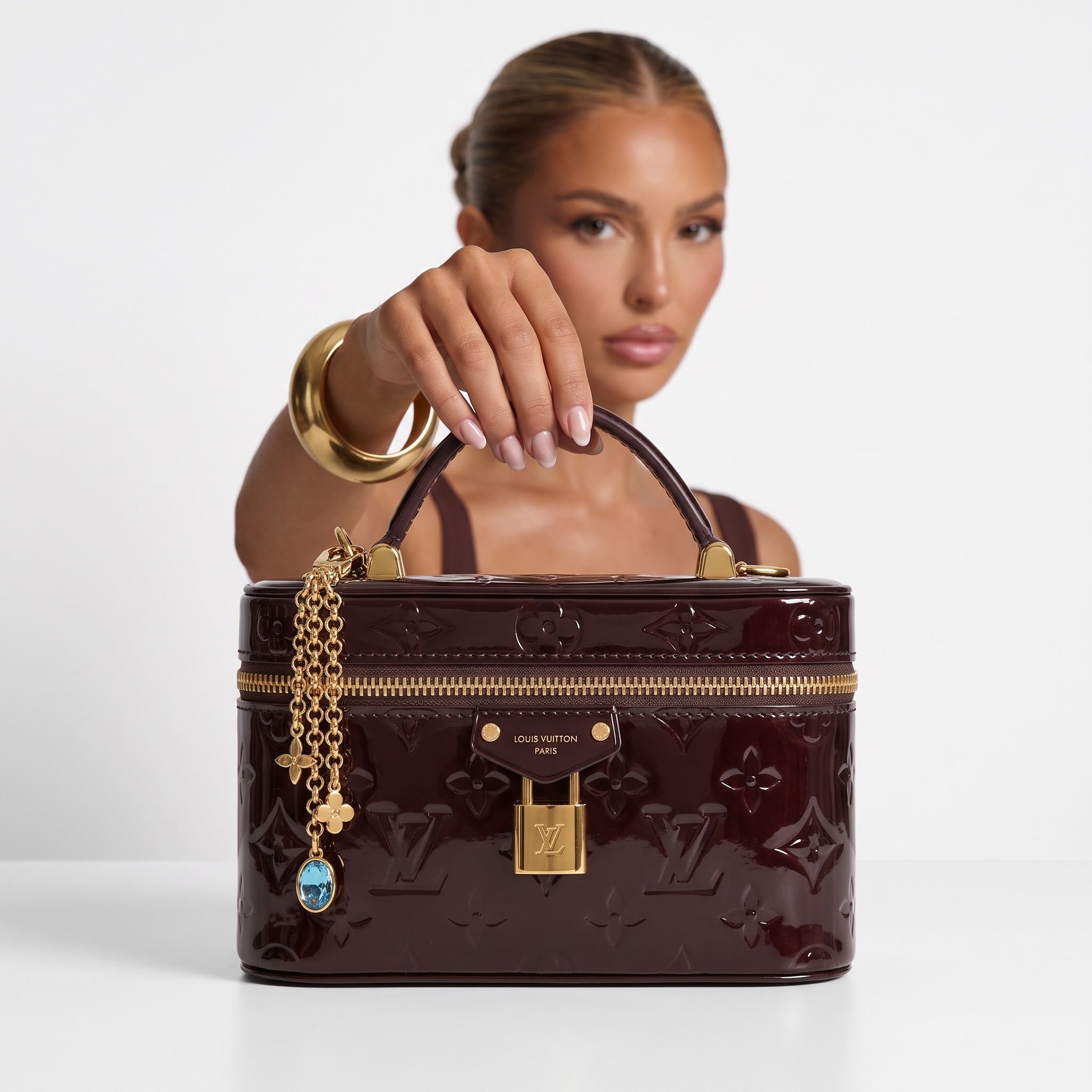 Louis Vuitton small burgundy patent monogram vanity bag with gold hardware and chain charm