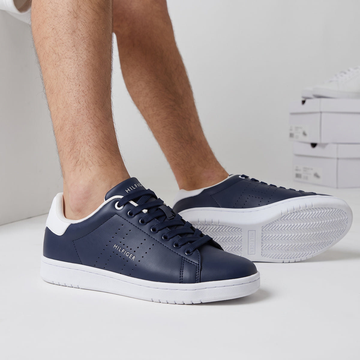 Tommy Hilfiger navy low-top sneakers with white heel and perforated side
