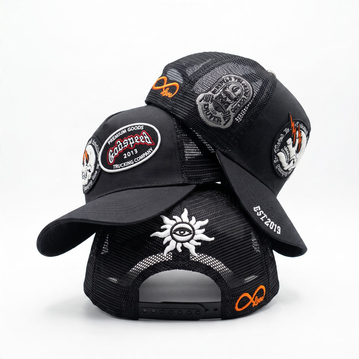 black trucker cap with multiple embroidered patches and mesh back