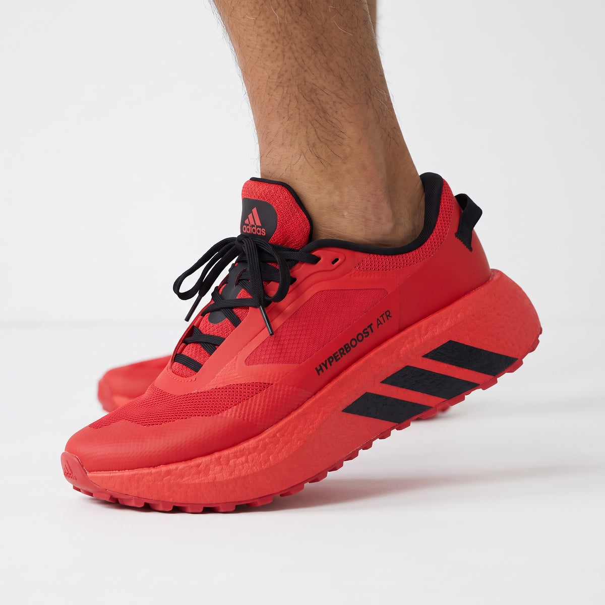 red adidas Hyperboost ATR sneaker with black accents