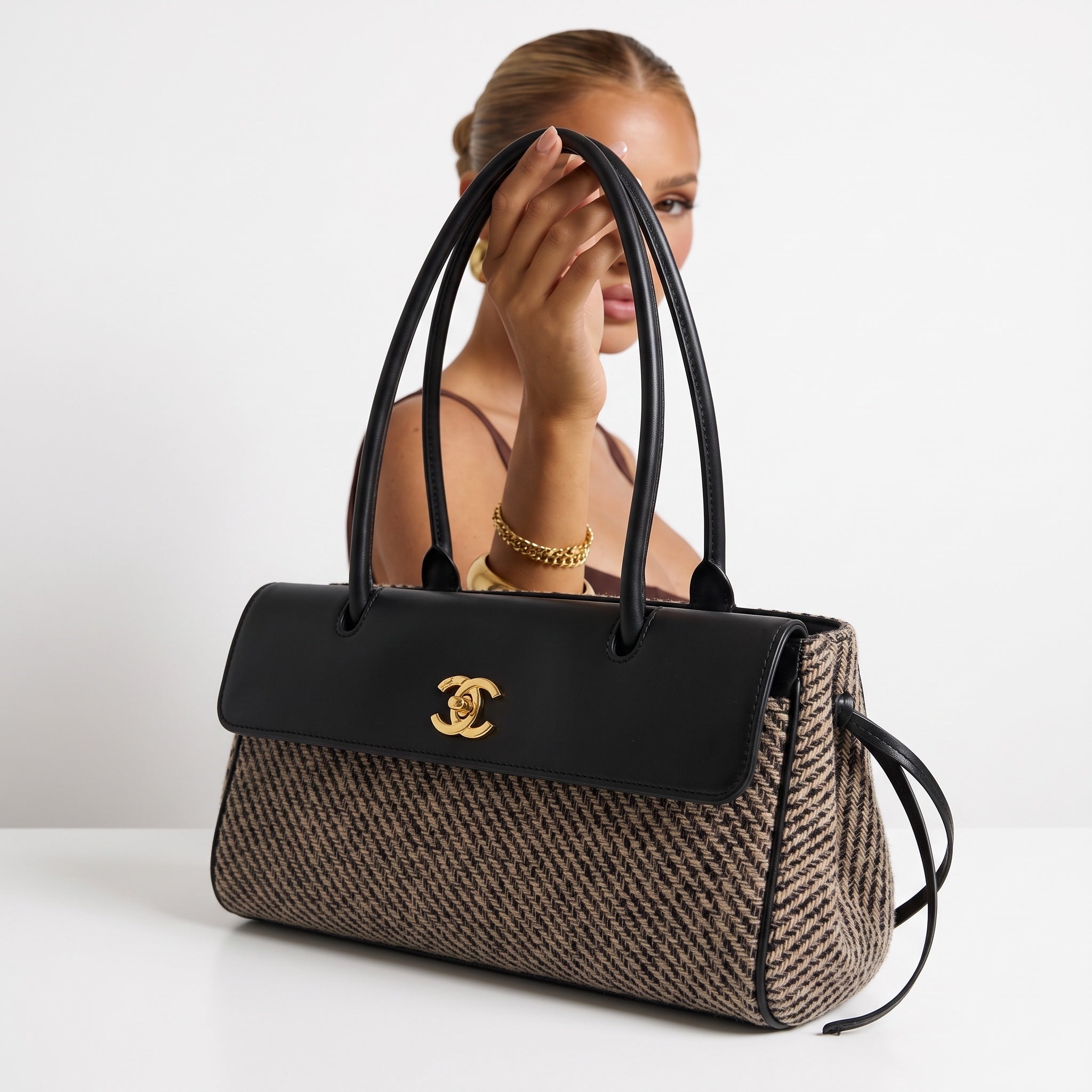 Chanel top-handle bag with black leather flap, gold CC hardware and beige patterned body